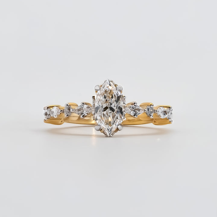 A gold engagement ring featuring a marquise-cut diamond at the center, held by six prongs.