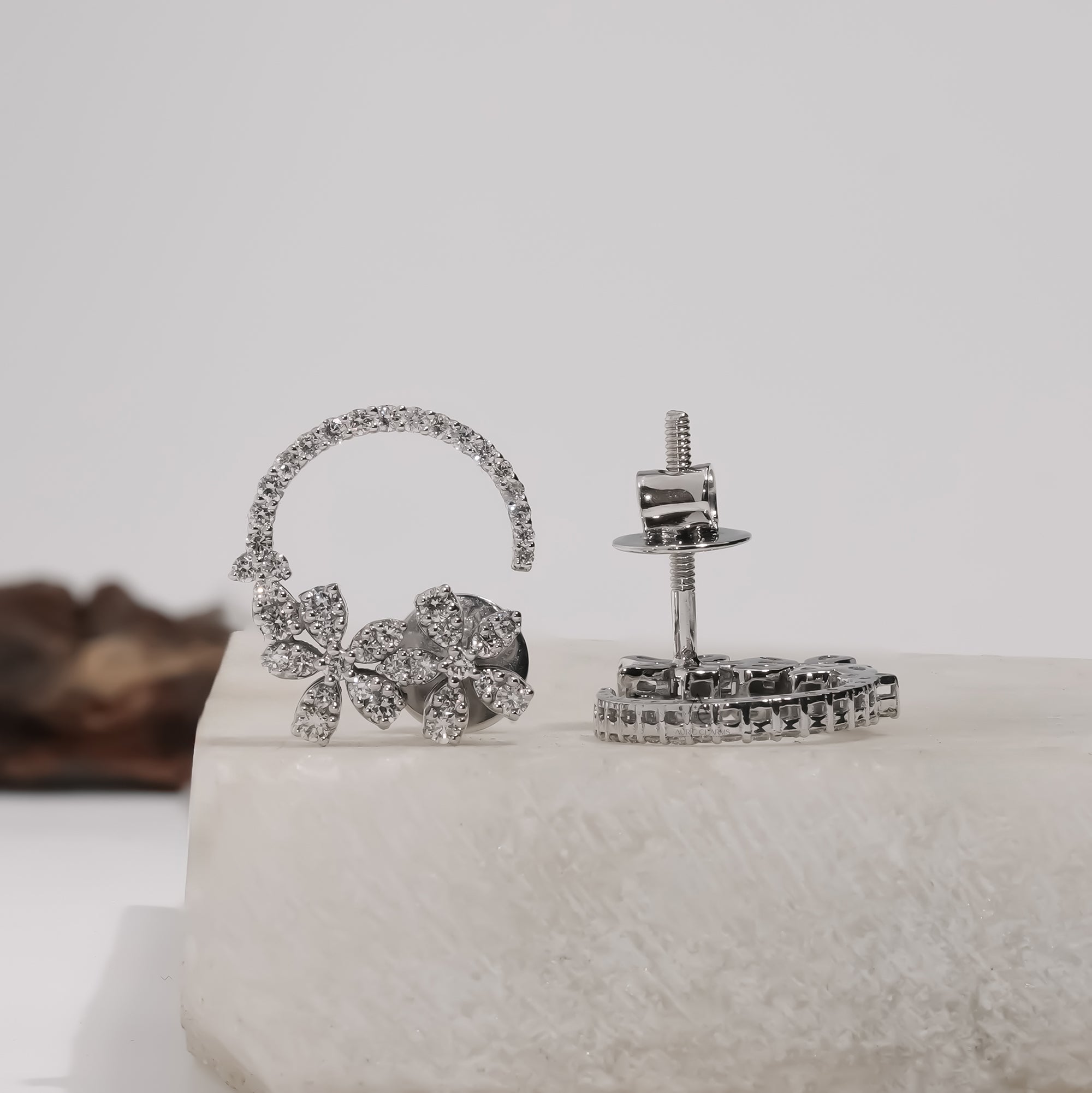 Delicate lab-grown diamond hoop earrings, elegantly shaped like blossoms, radiate luxury and sustainable beauty.