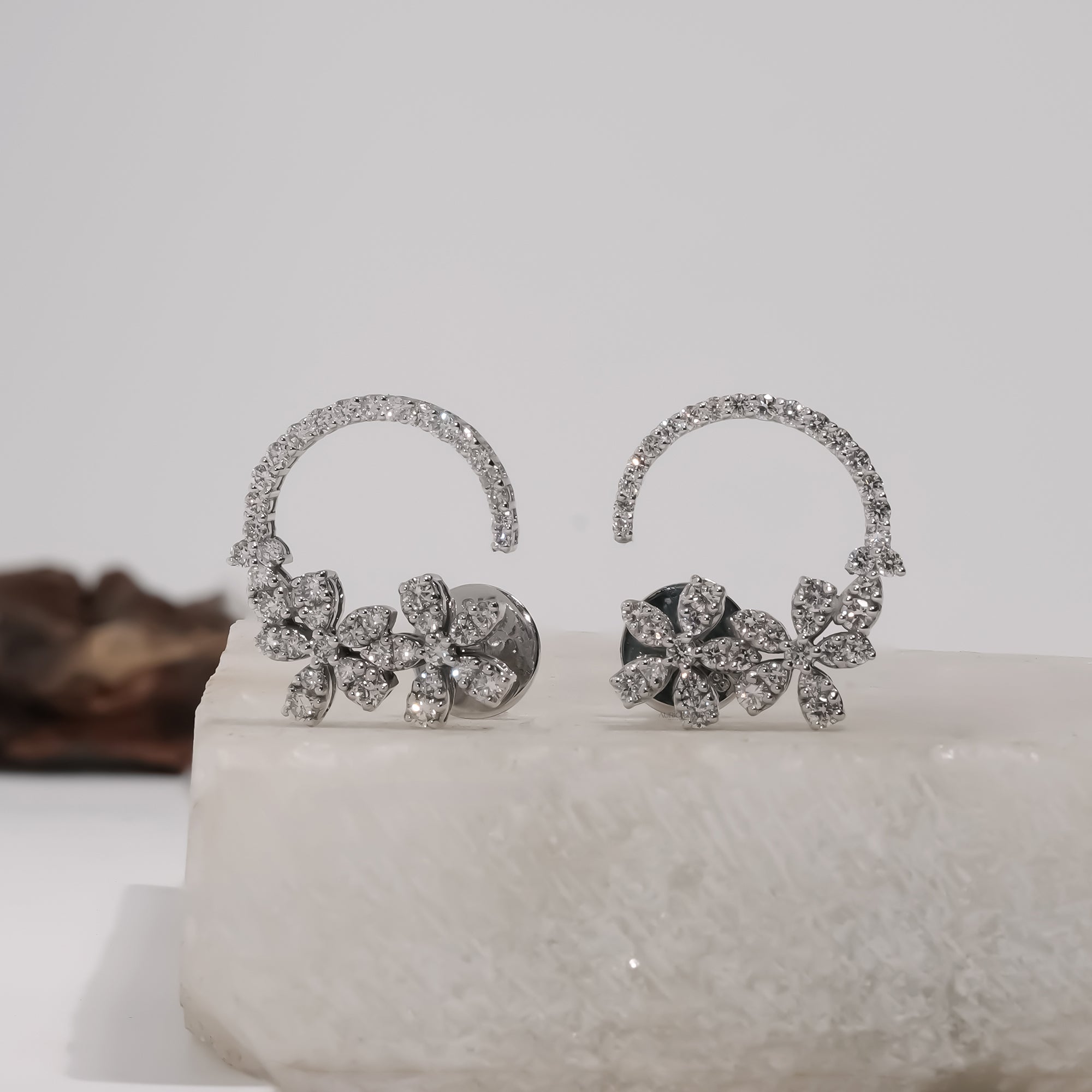 Elegantly showcasing Rosalie Floral Lab-Grown Diamond Hoop Earrings, radiating luxury and sustainable beauty with their floral design.