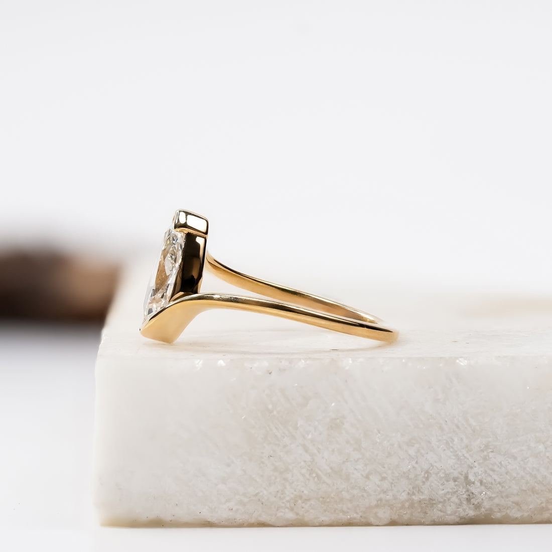 Gold ring with pear-cut diamond in a modern open setting