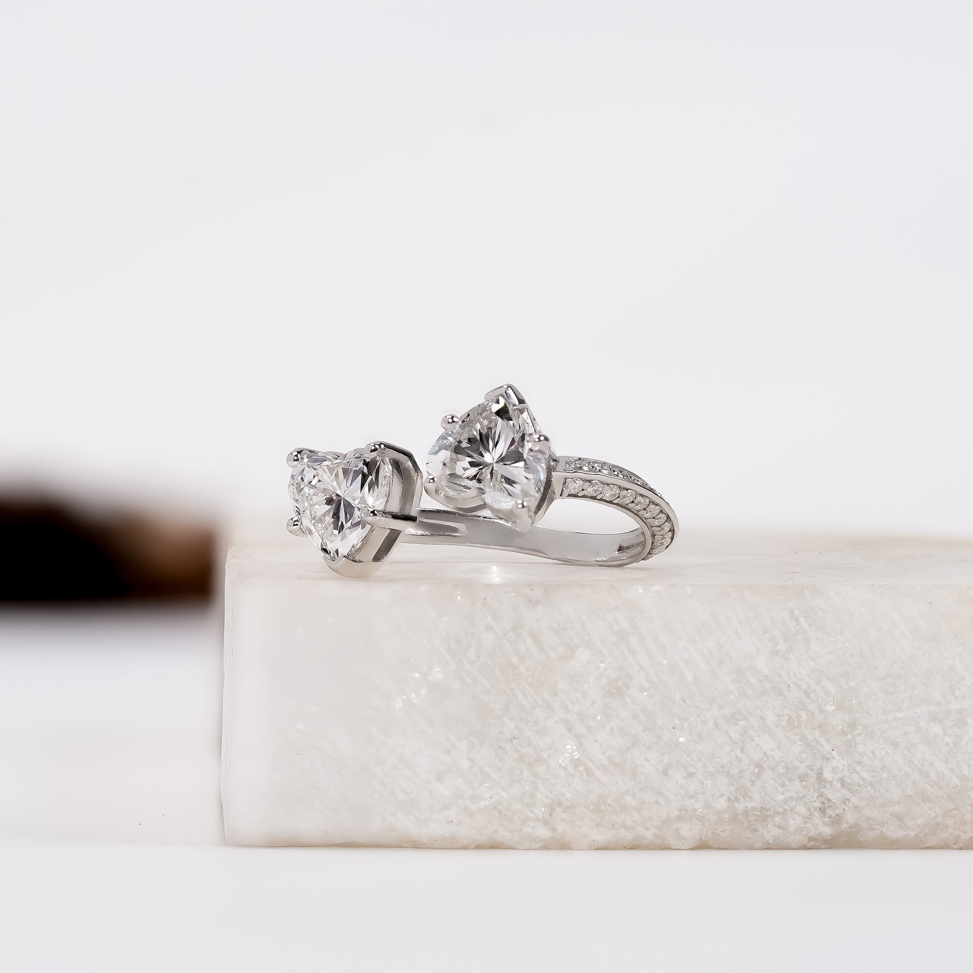Elegant silver ring with two sparkling heart-cut gemstones