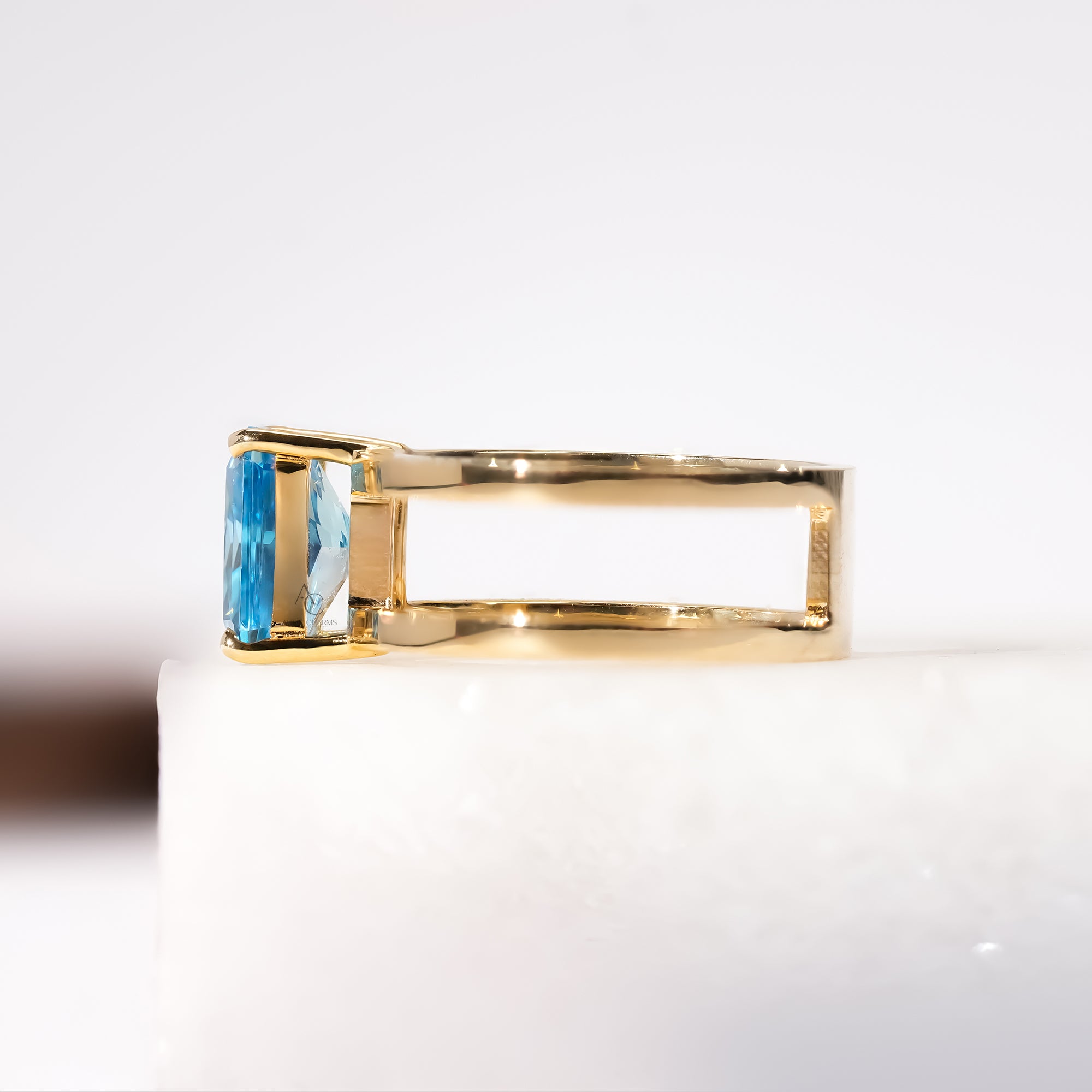 Elegant gold ring showcasing a radiant blue stone in a four-prong setting.