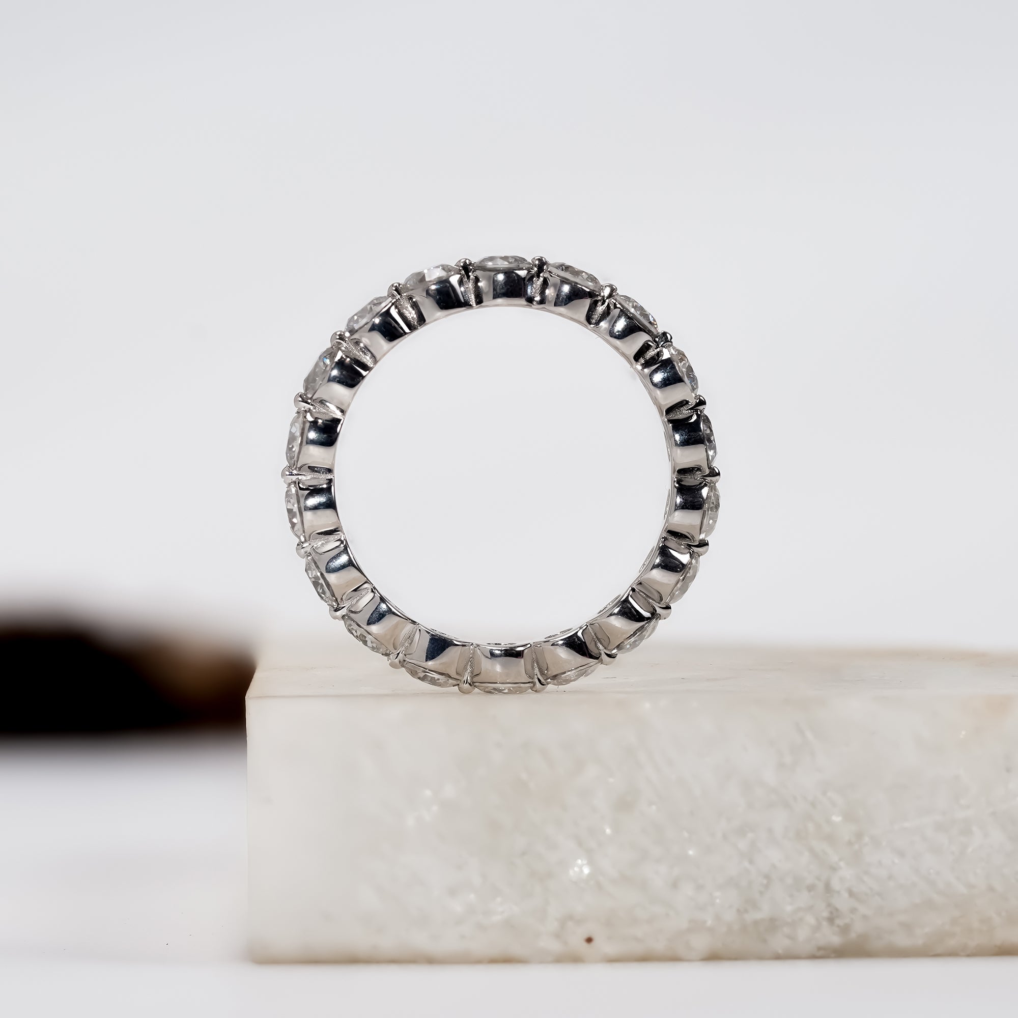 White gold diamond eternity band with round brilliant-cut stones, elegant fine jewelry ring for weddings or anniversaries.