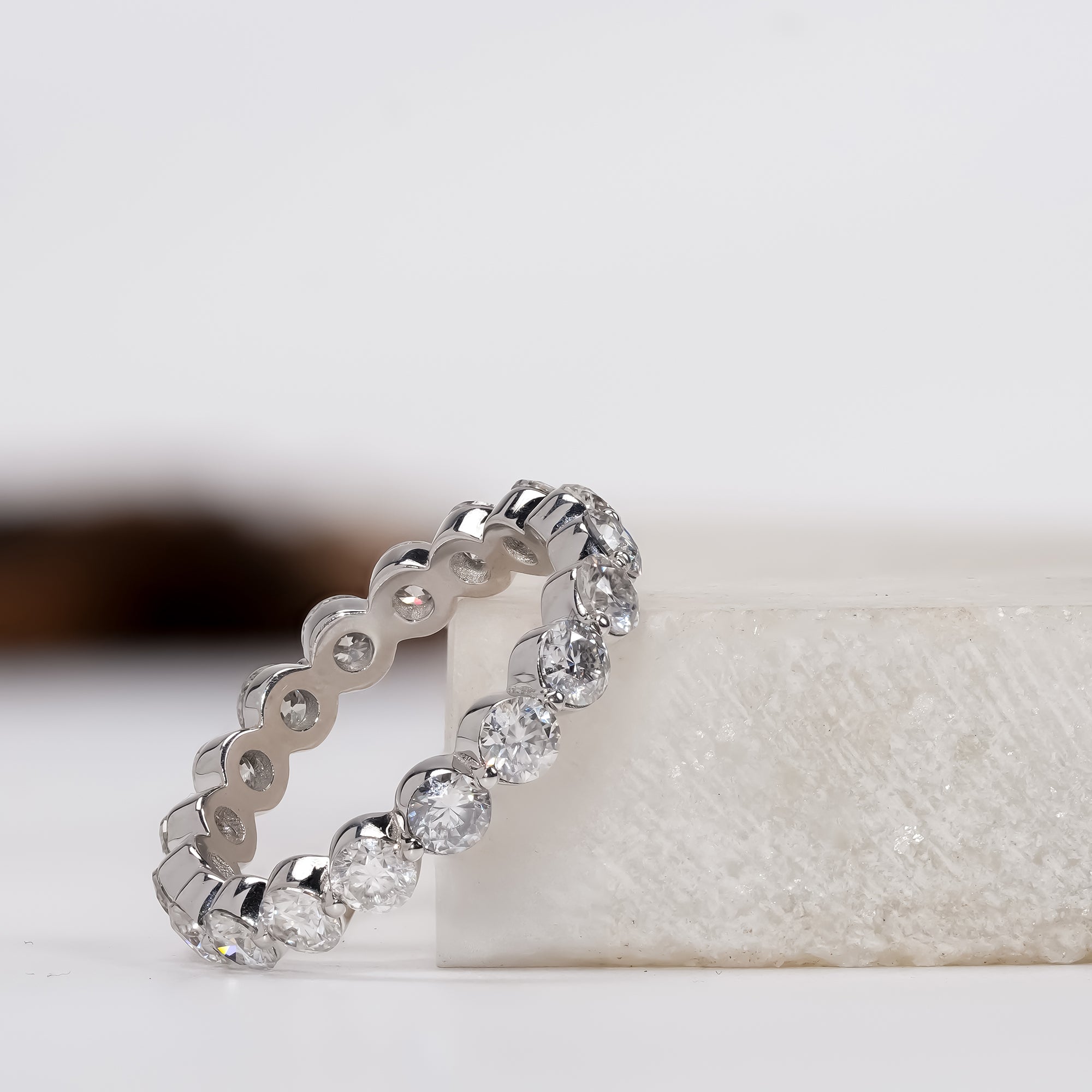 Sparkling diamond eternity ring in polished white gold, capturing timeless elegance and refined craftsmanship.
