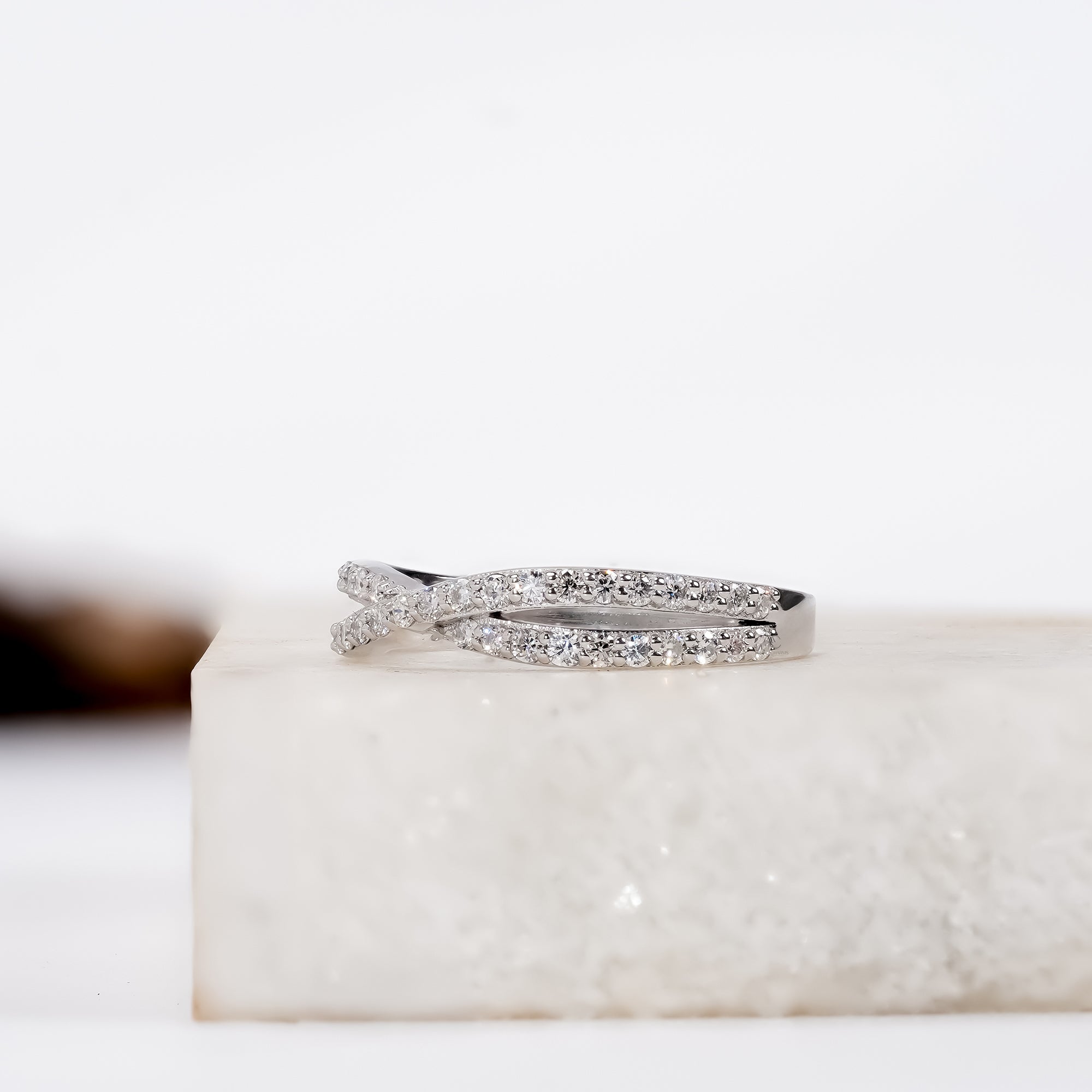 Delicate infinity-shaped diamond ring set in silver