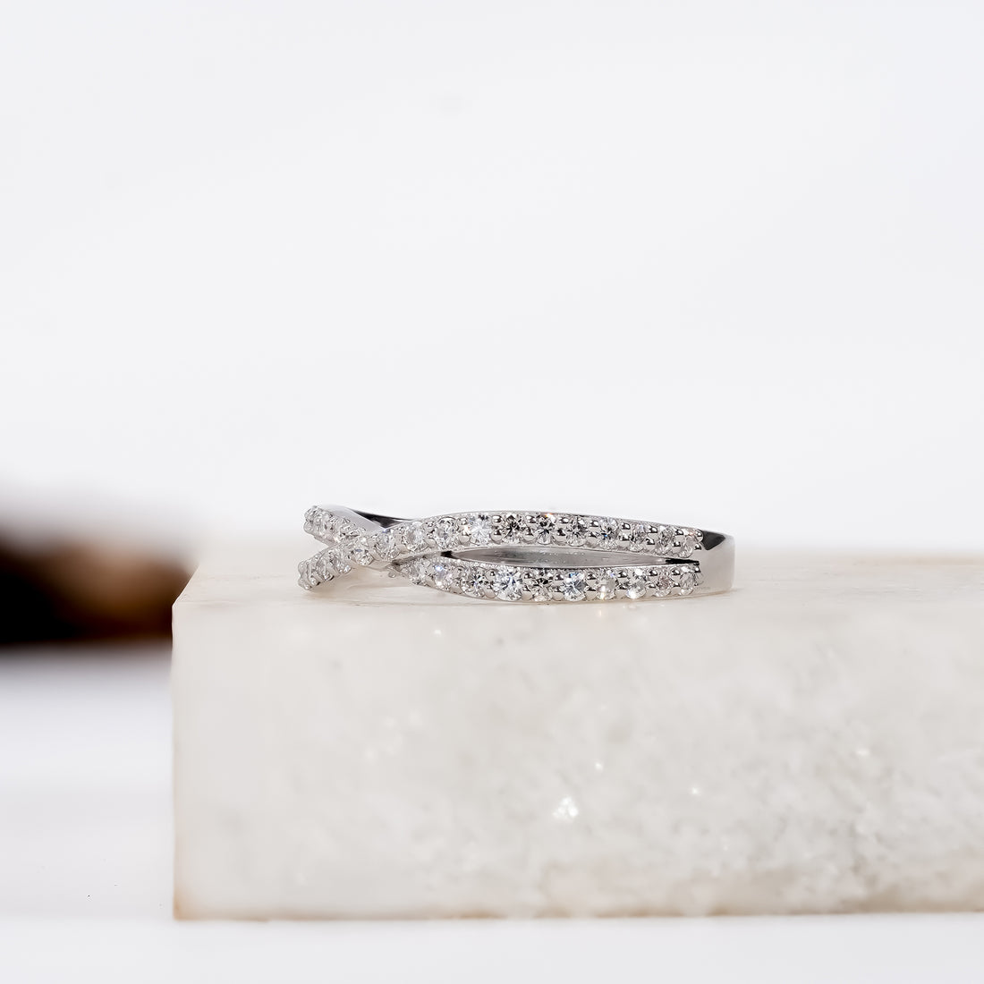 Delicate infinity-shaped diamond ring set in silver