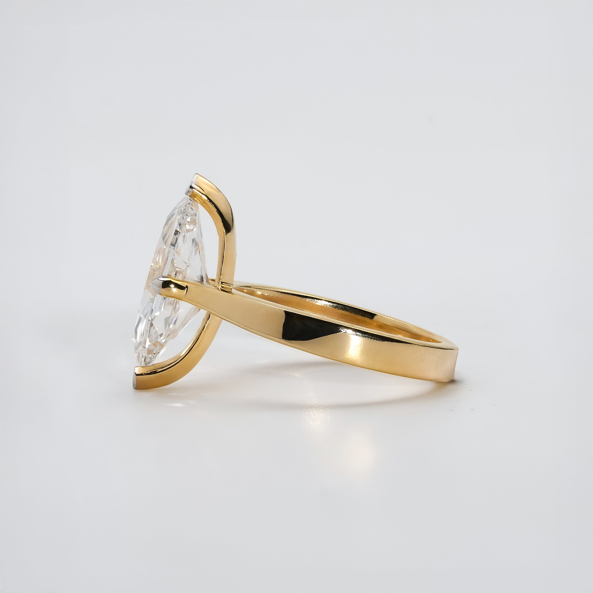 Marquise-cut diamond solitaire ring in 14k yellow gold with a smooth, modern band for a timeless and sophisticated look.