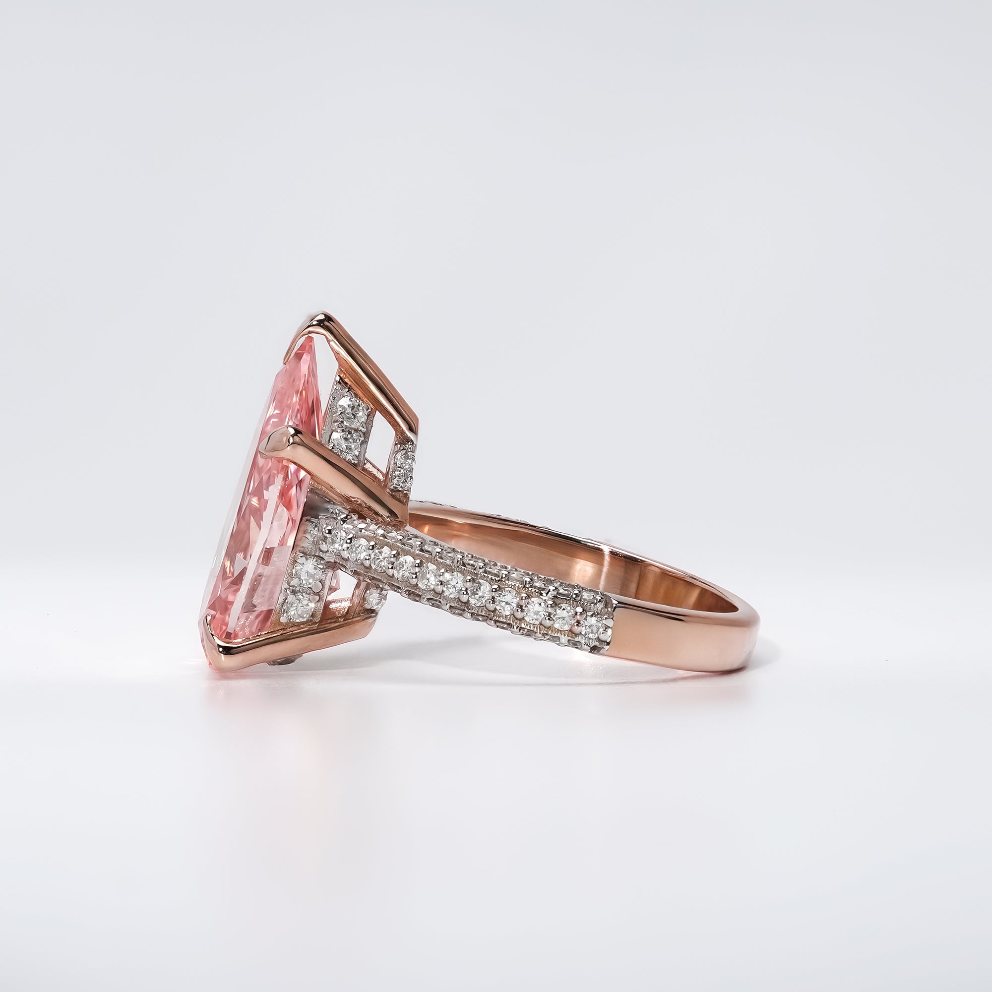 Pear-shaped pink gemstone engagement ring in rose gold with a pavé diamond band, blending modern glamour with timeless romance.