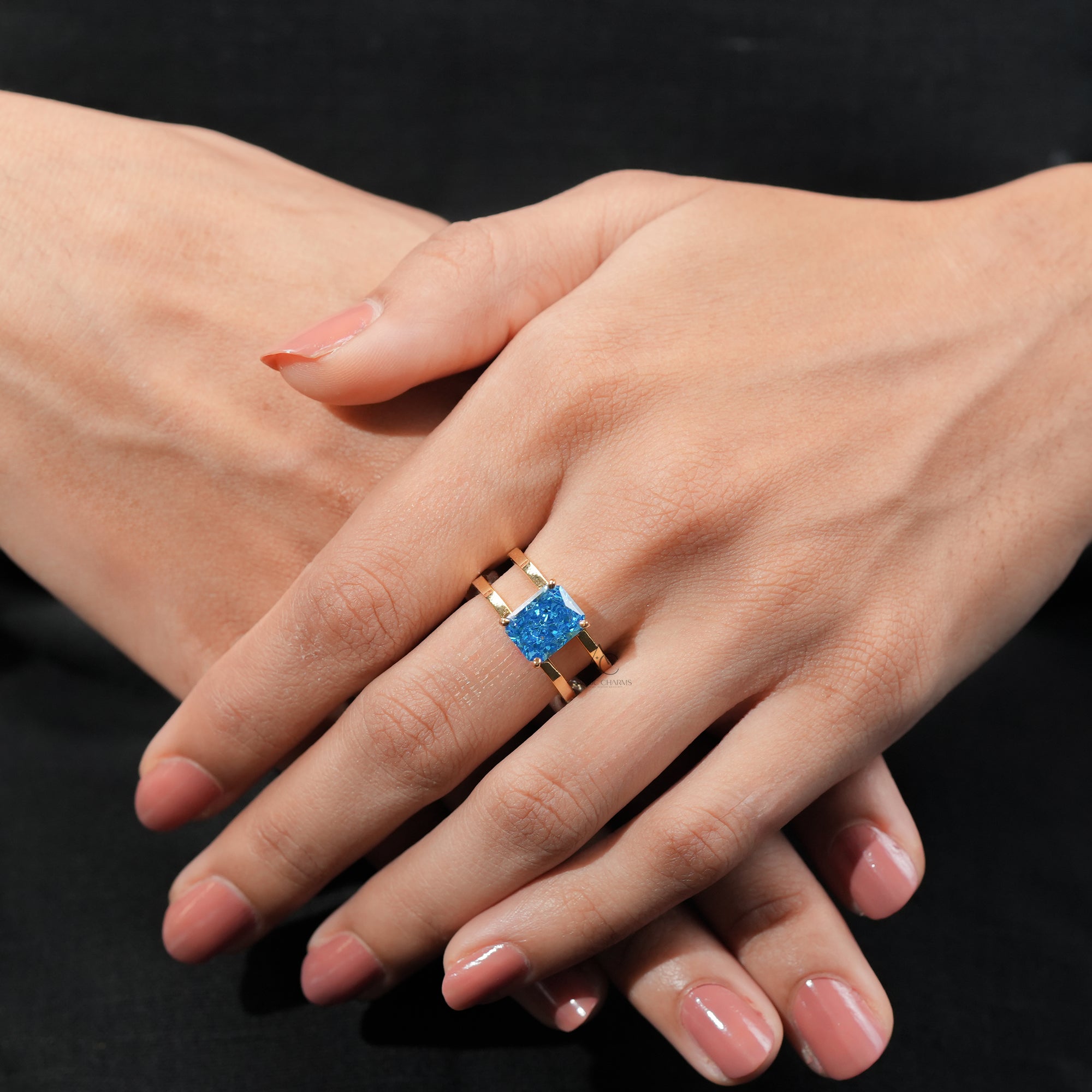 A luxurious blue gemstone ring with a gold double band design.