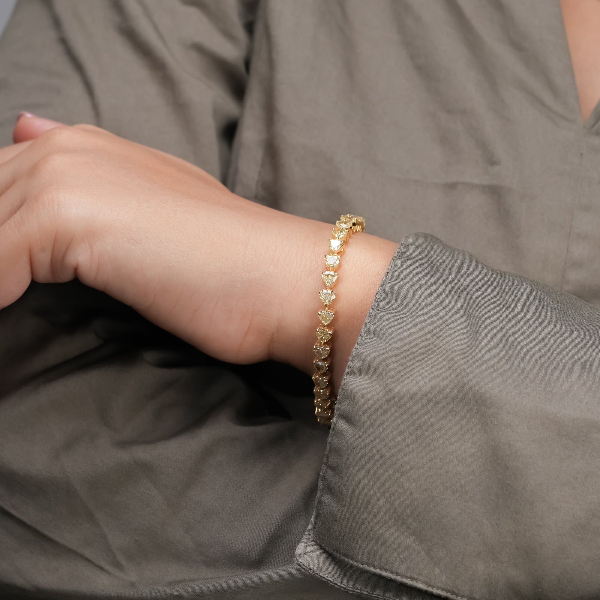 An exquisite yellow gold bracelet with perfectly matched heart-cut diamonds, showcasing a flawless blend of brilliance, balance, and refined luxury.