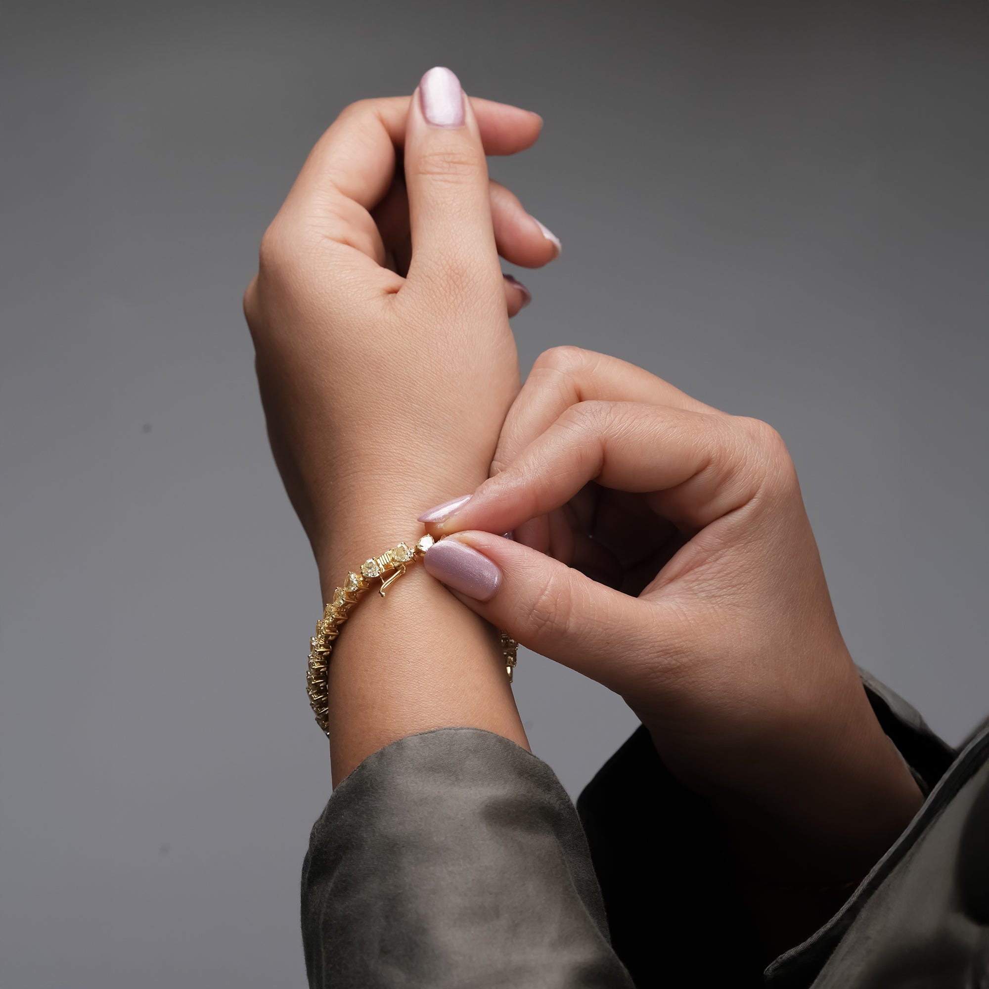 A graceful gold bracelet featuring heart cut diamonds in a shimmering sequence, blending timeless glamour with contemporary elegance.