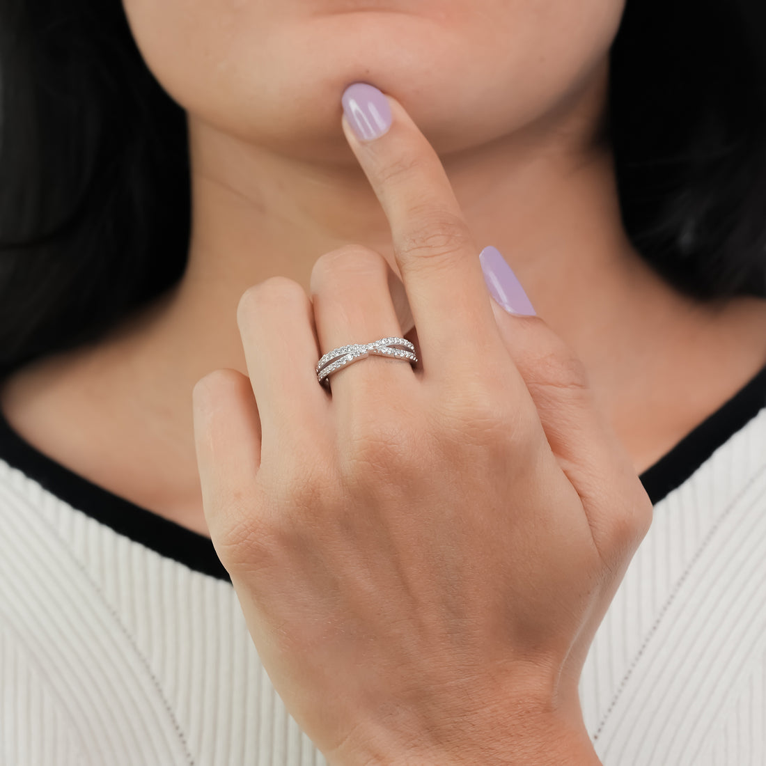 Sparkling infinity engagement ring with diamond accents in silver.