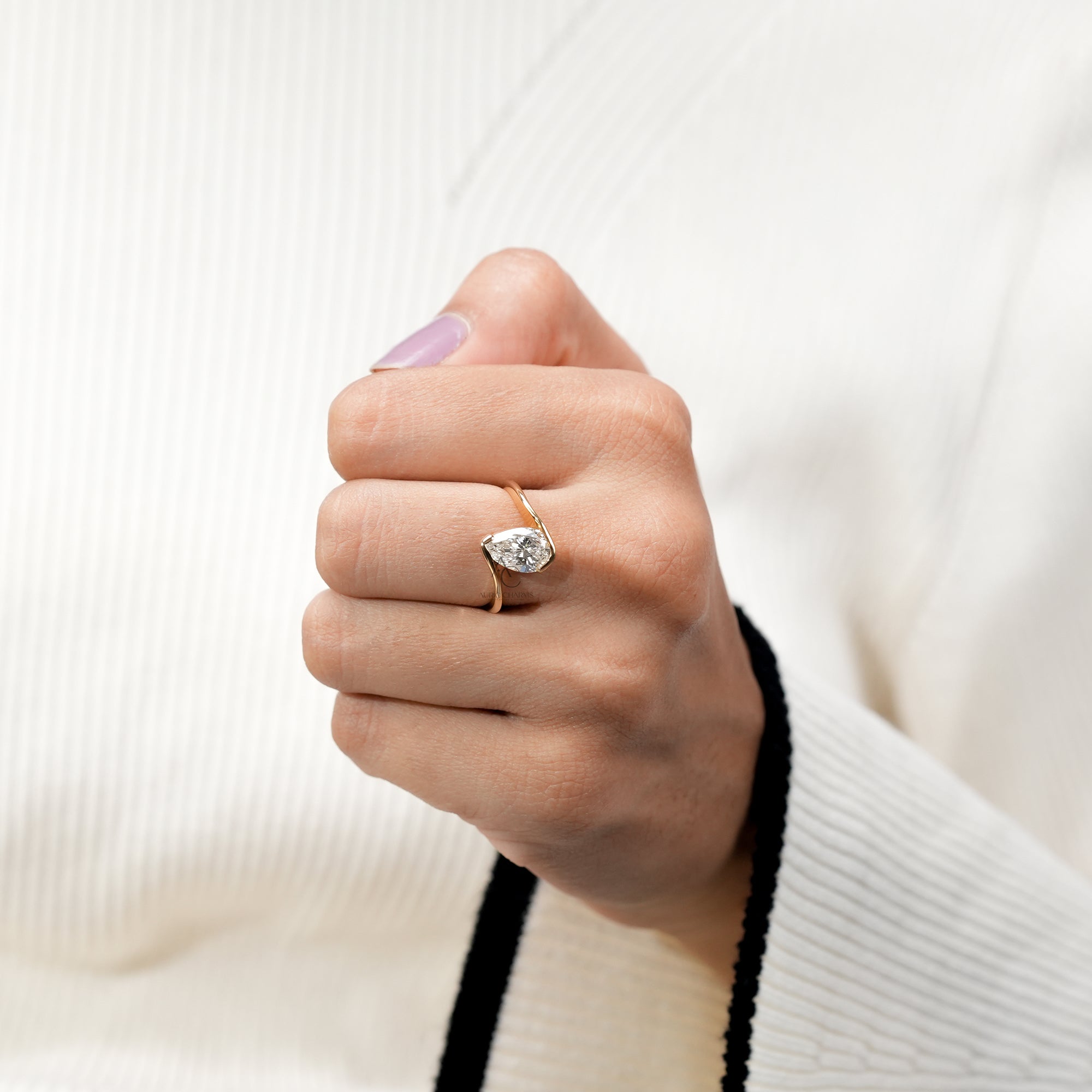 Sleek gold pear-cut diamond ring with contemporary open setting