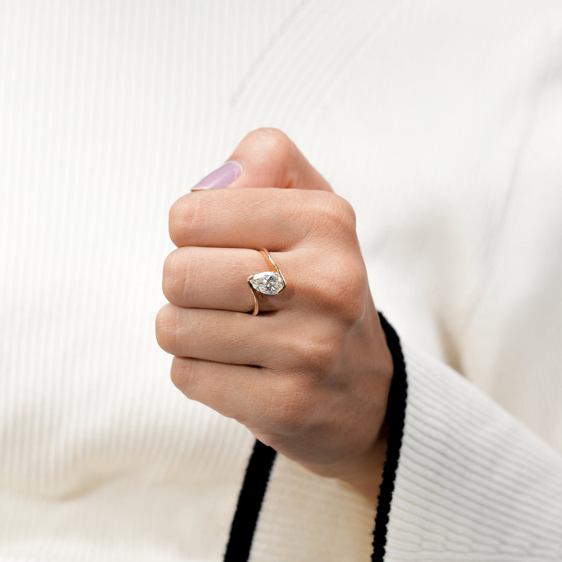 Sleek gold pear-cut diamond ring with contemporary open setting