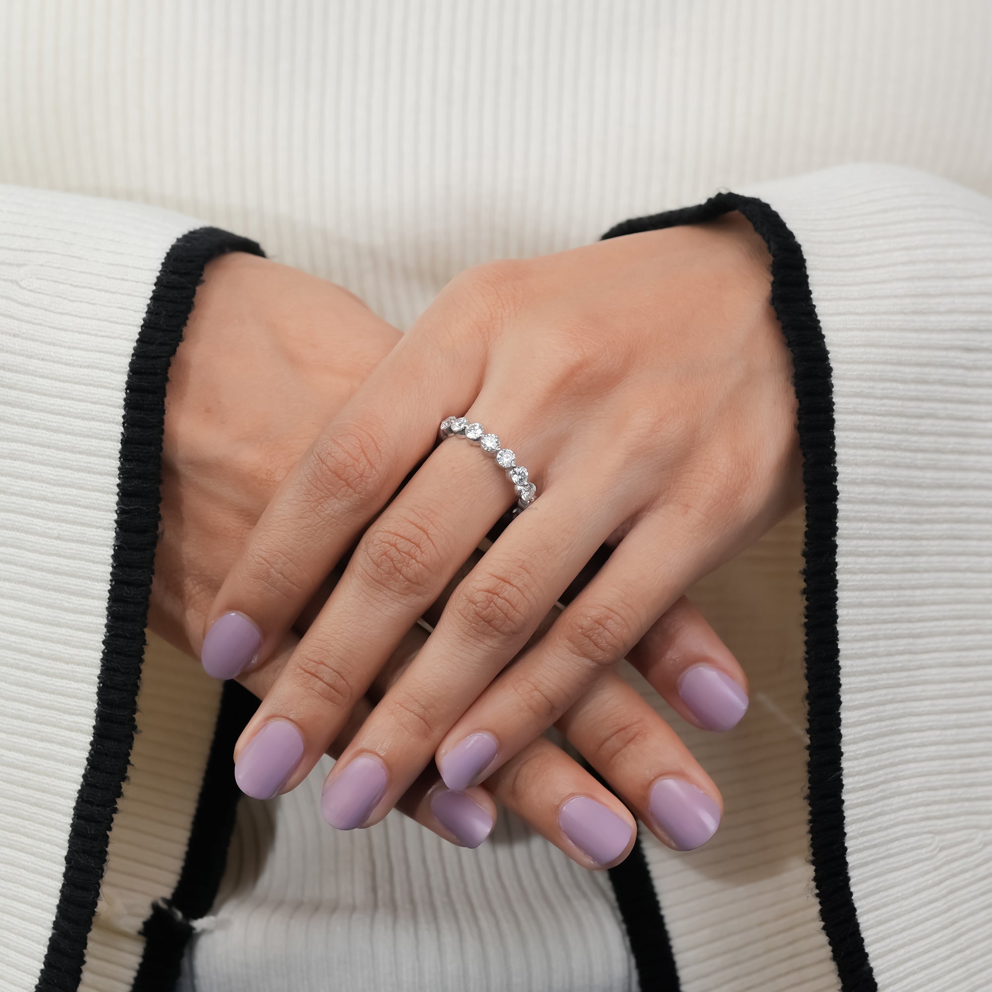 White gold eternity ring with round diamonds.