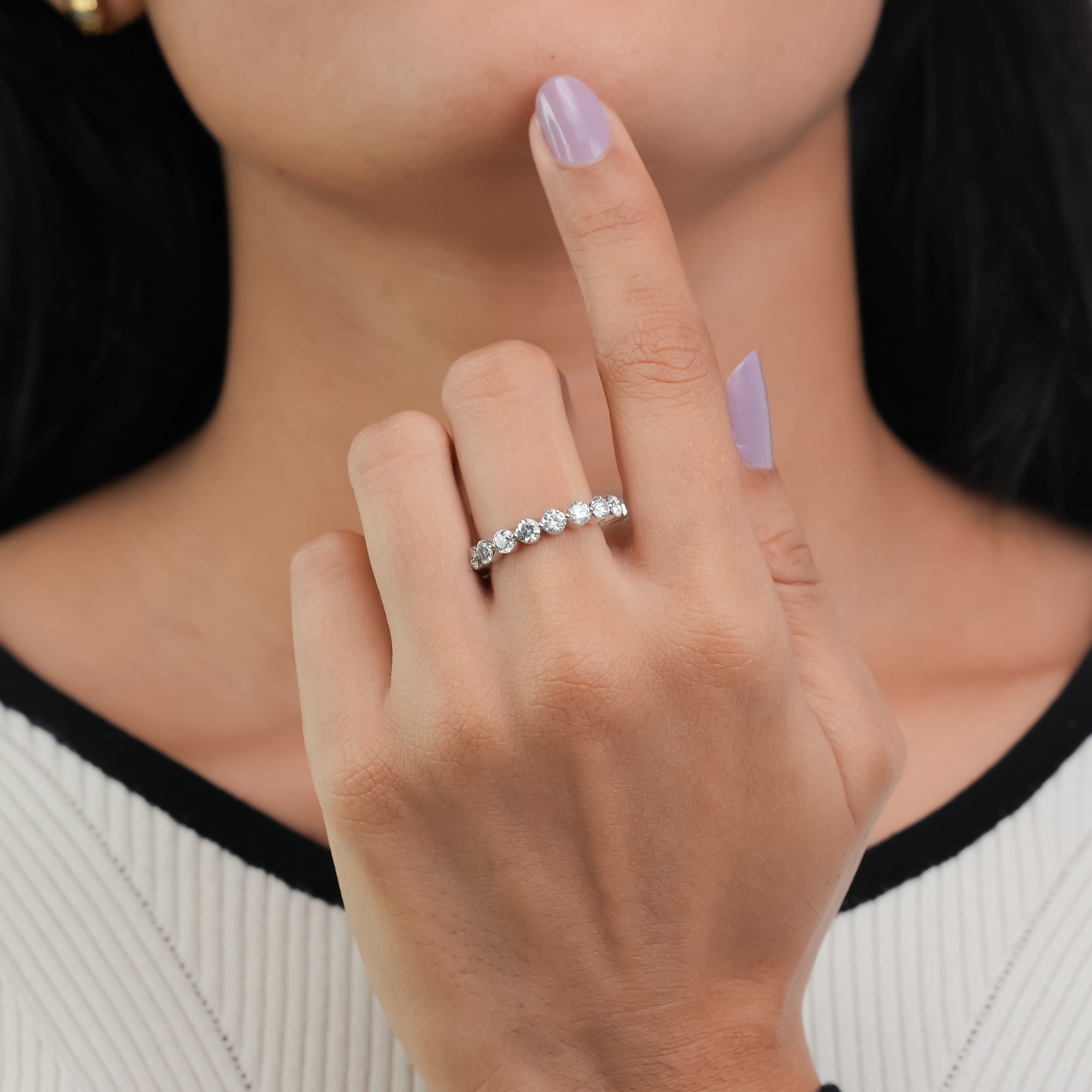 White gold eternity ring with perfectly matched round diamonds in a sleek shared-prong setting.