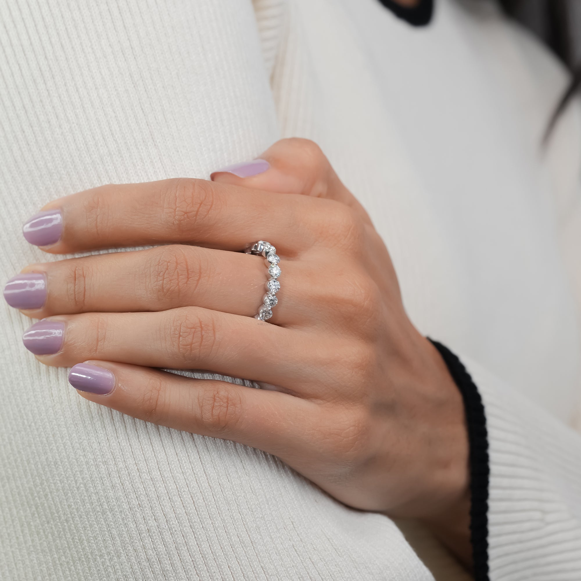 Diamond band featuring a full circle of round brilliant stones in a gleaming white gold design.