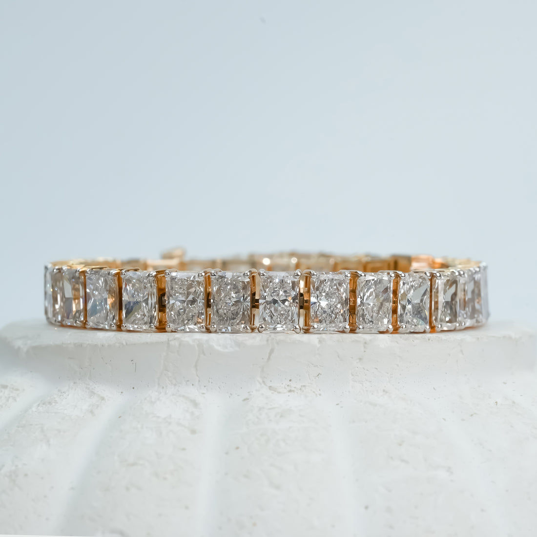 A radiant gold bracelet adorned with square-cut diamonds, beautifully arranged in a seamless pattern, exuding elegance and timeless sophistication.