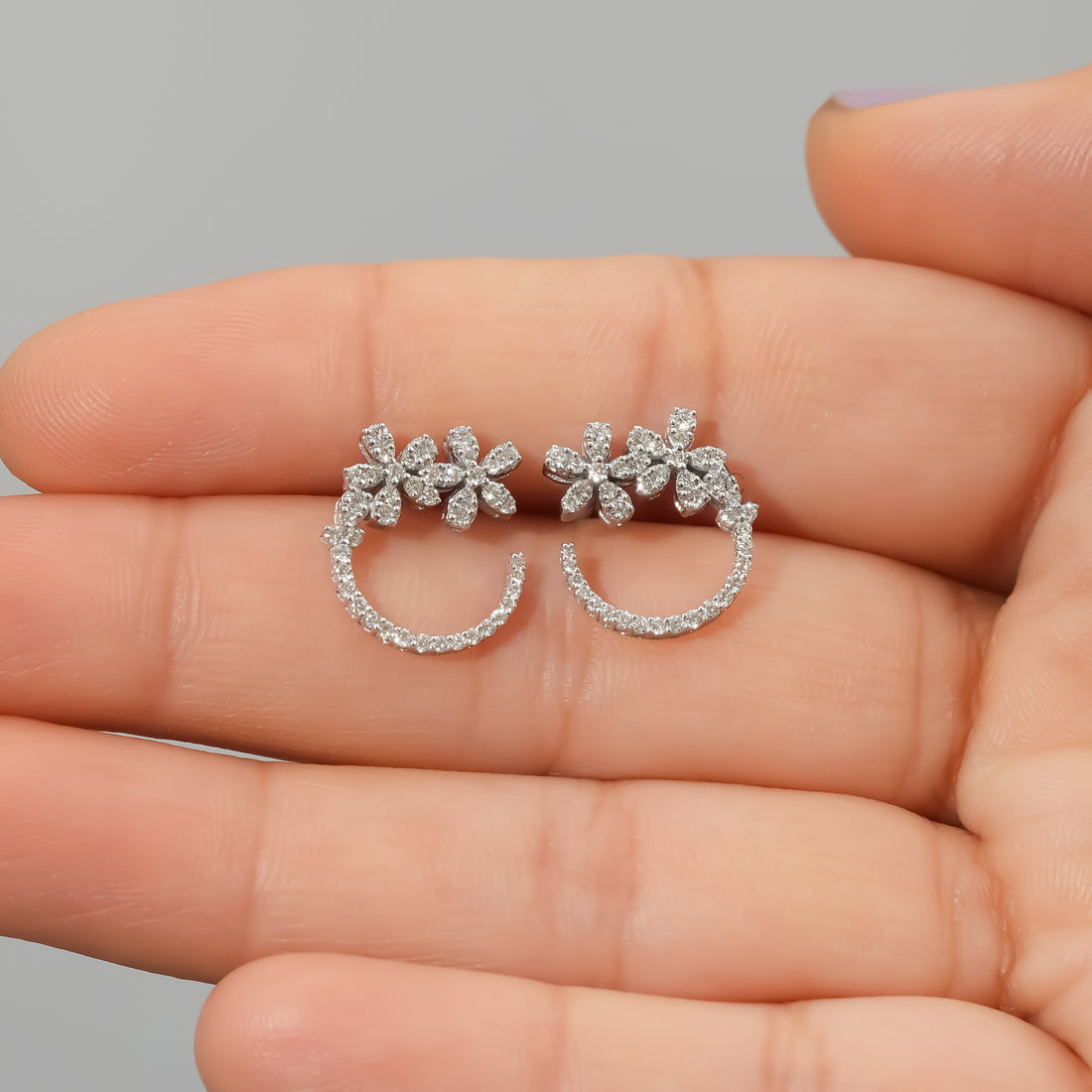 Delicate Rosalie floral lab-grown diamond hoop earrings shown in hand, embodying sustainable luxury and elegant grace.