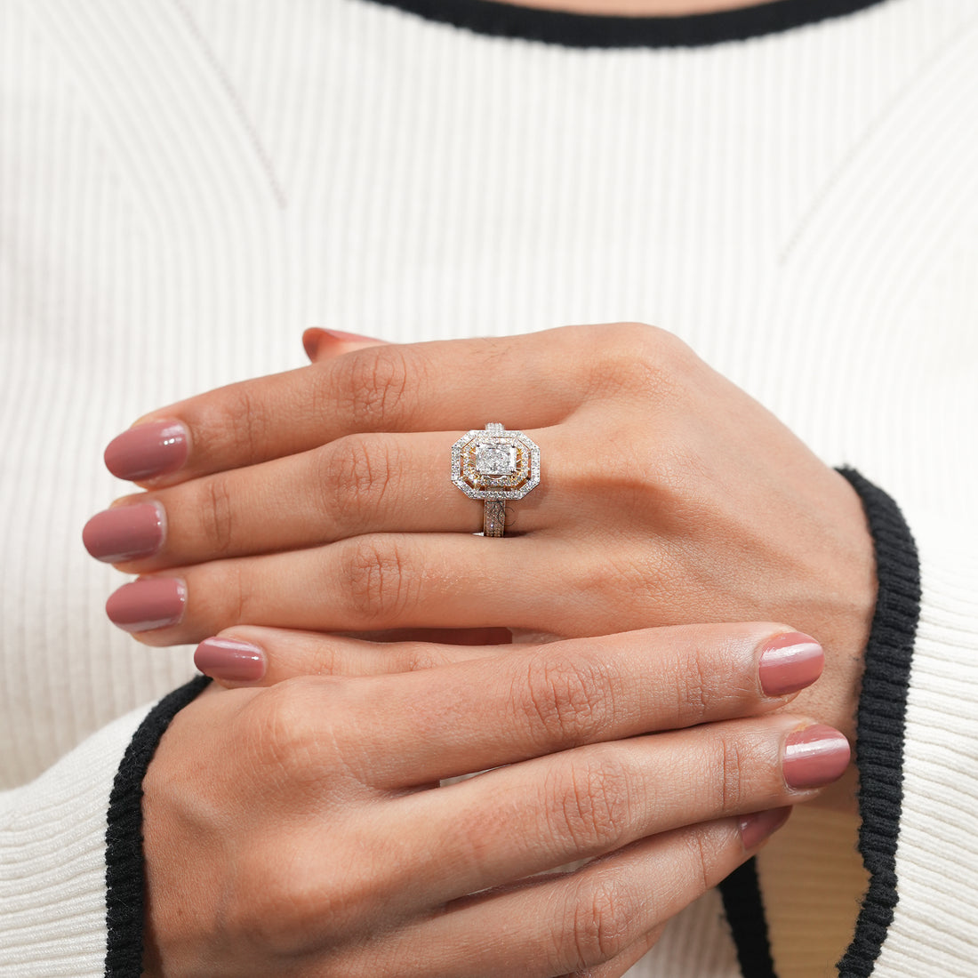 Radiant-cut diamond ring with layered halo detailing and diamond