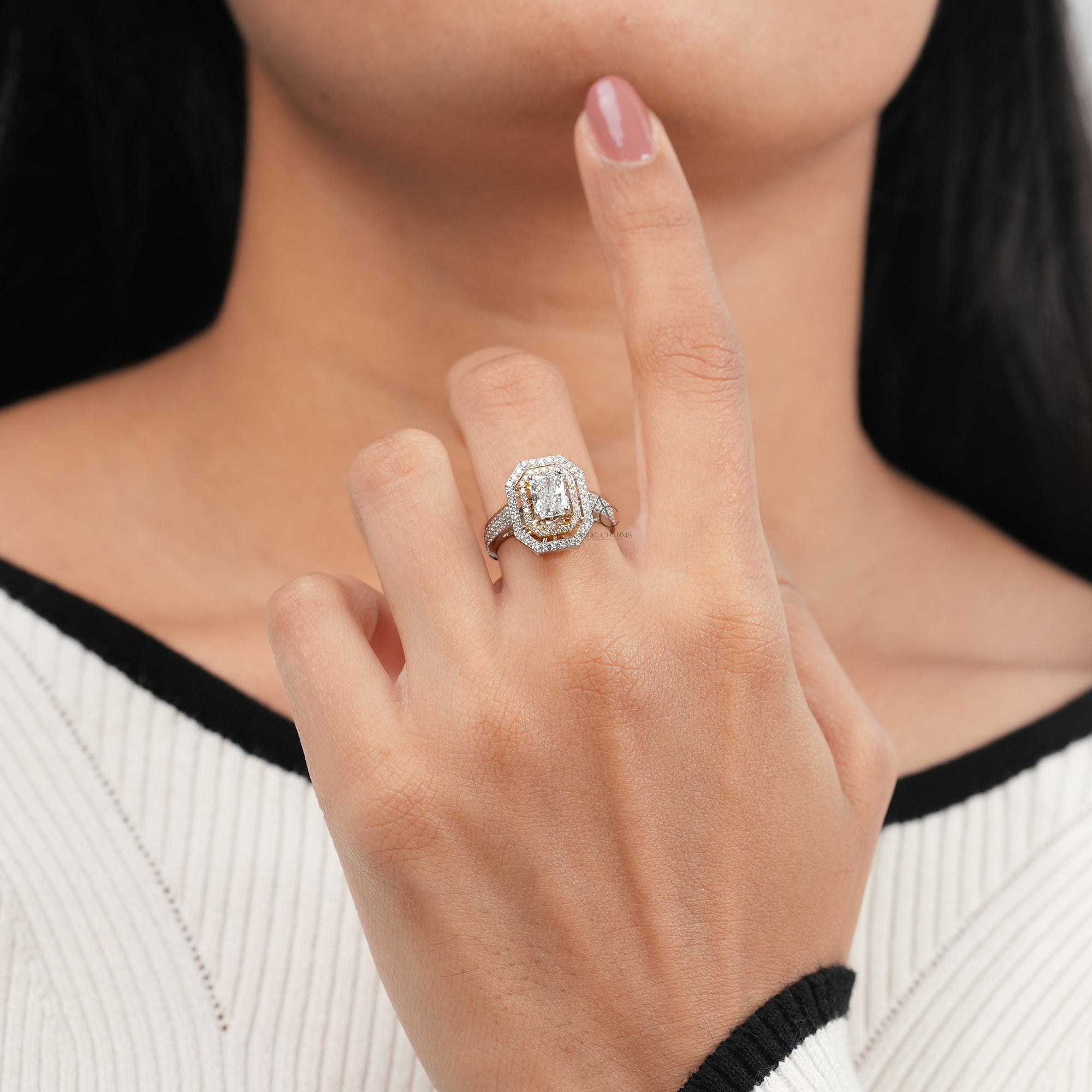 Radiant-cut diamond engagement ring with a double halo of round diamonds, a pavé-set band