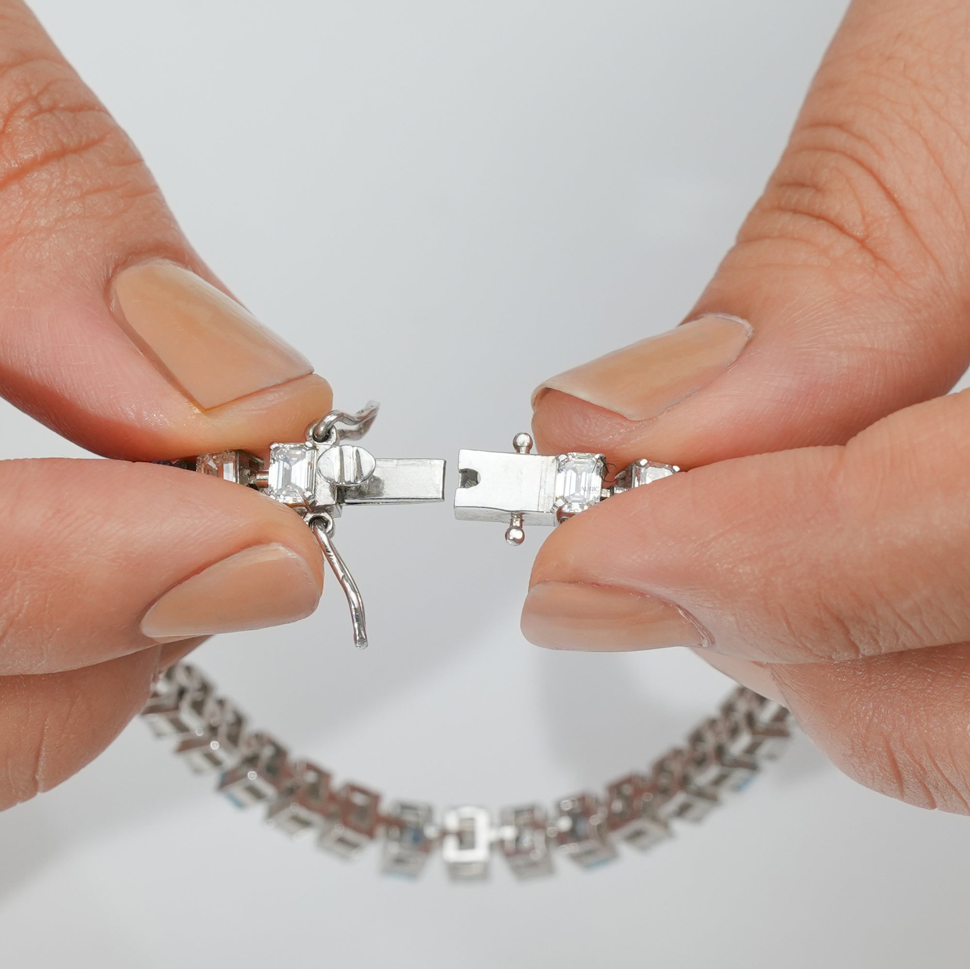 A delicate silver bracelet adorned with alternating blue and clear rectangular gemstones, evoking coastal elegance and serenity.