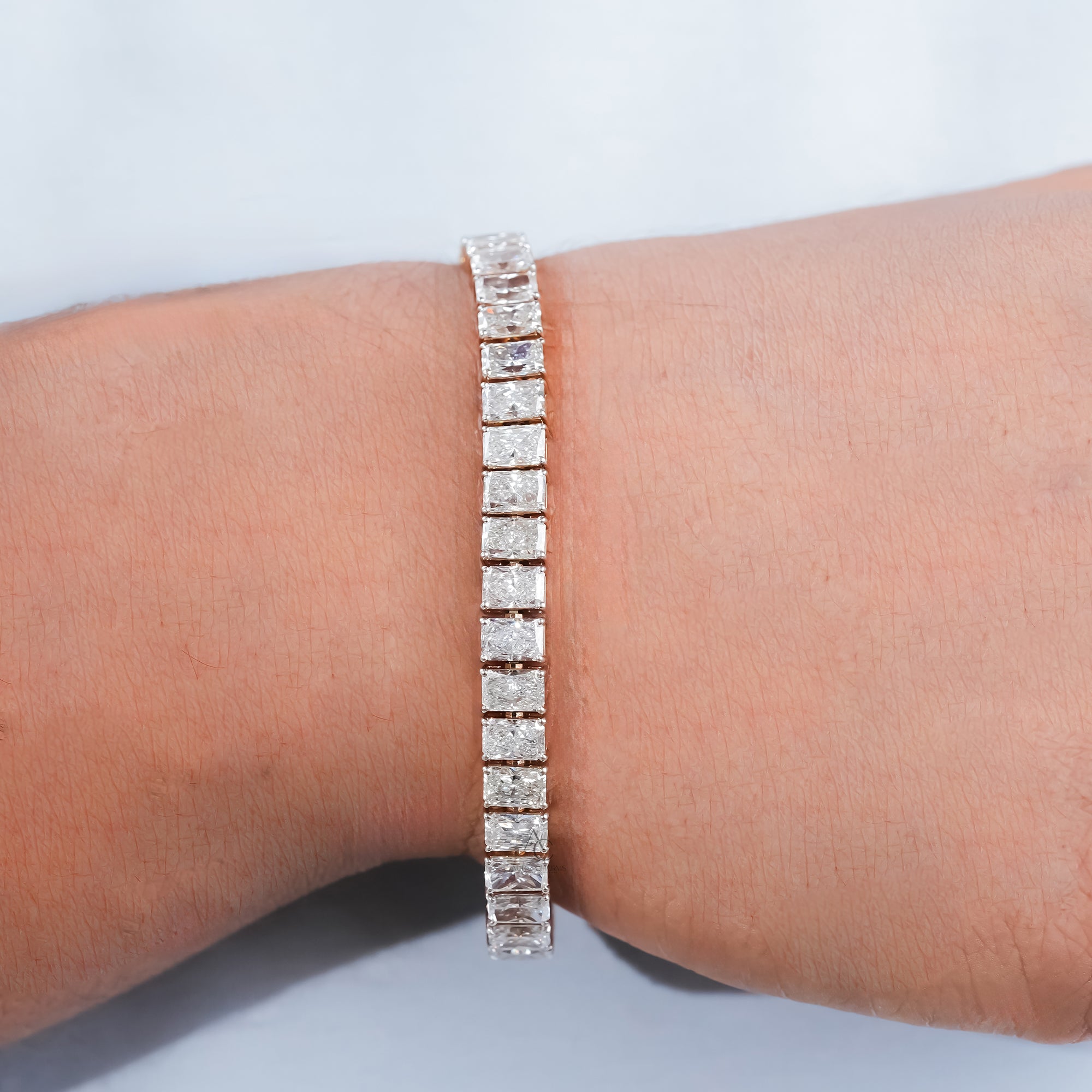 An exquisite yellow gold bracelet set with radiant-cut diamonds, showcasing masterful craftsmanship and a balance of brilliance and sophistication.