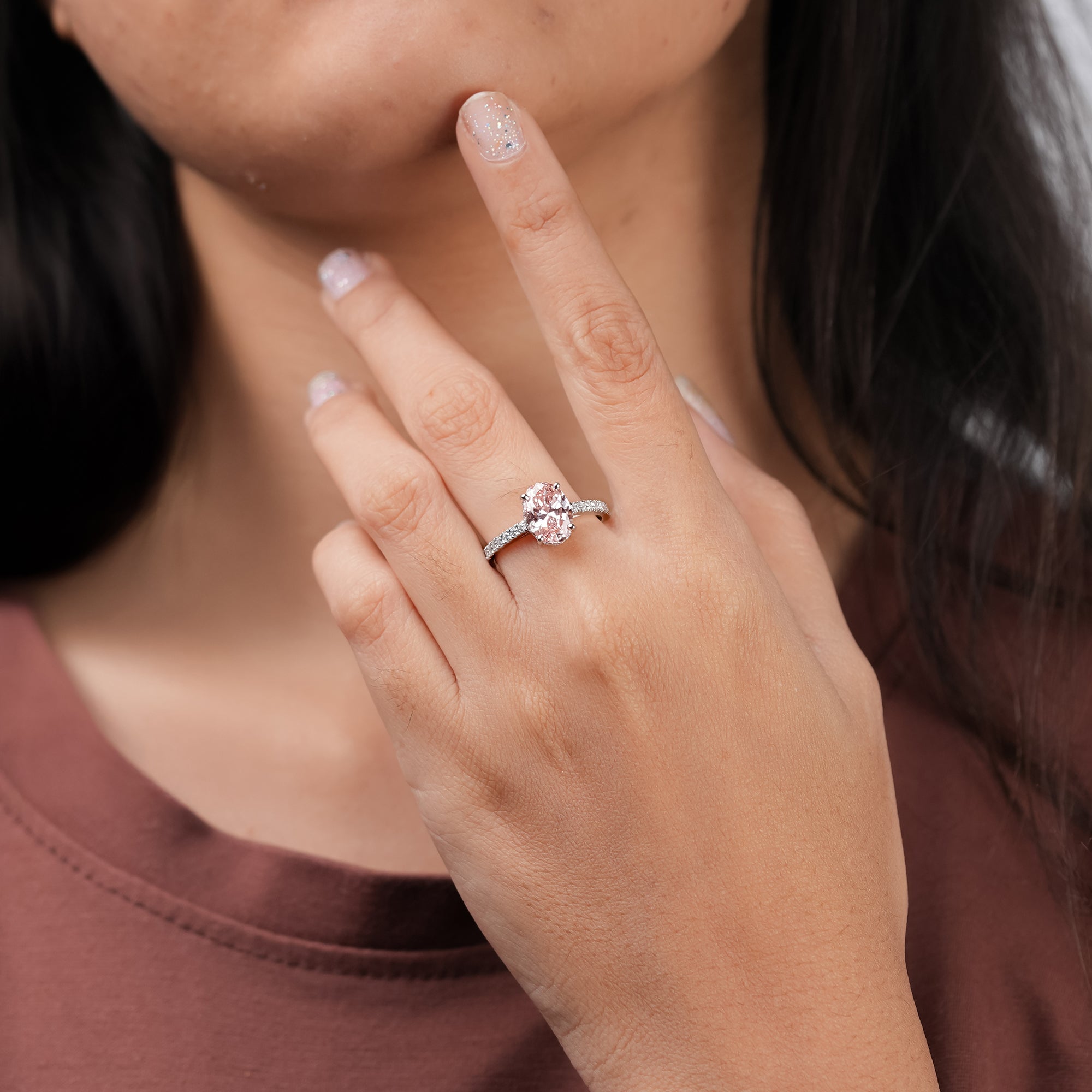 A stunning oval pink diamond ring symbolizing grace and romance, accented with sparkling white diamonds.