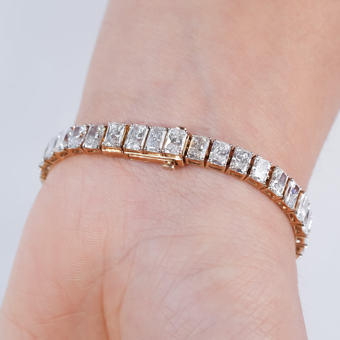 Gold diamond bracelet with radiant-cut stones in a channel setting, perfect for elegant evening wear or luxury gifting.