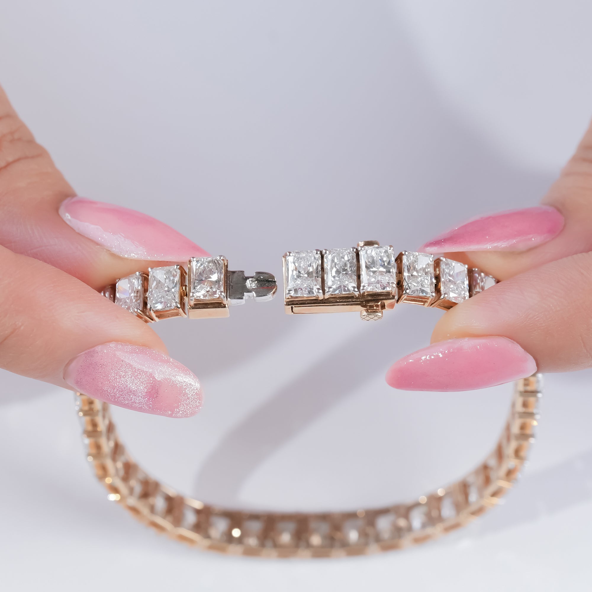 Radiant-cut diamond tennis bracelet in yellow gold, featuring channel-set diamonds for a clean, polished, and elegant finish.
