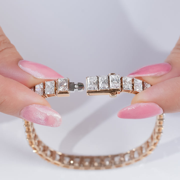 Radiant-cut diamond tennis bracelet in yellow gold, featuring channel-set diamonds for a clean, polished, and elegant finish.