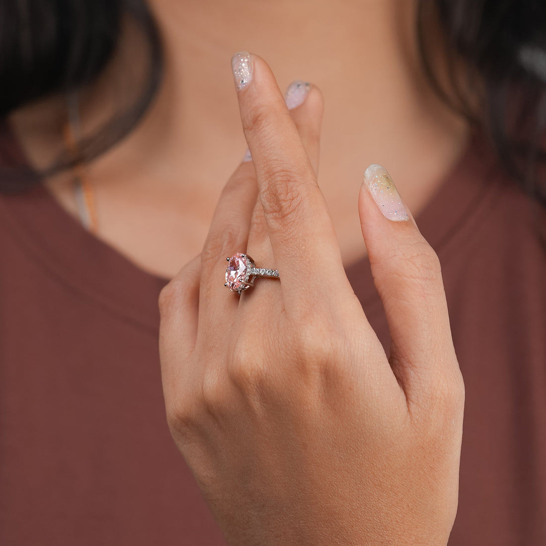 Fancy pink oval diamond solitaire ring, four-prong setting, pavé side stones, crafted in 18k white gold.