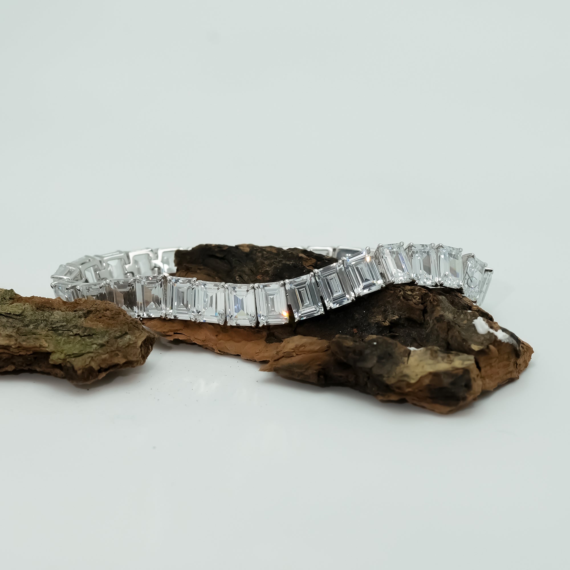 A dazzling white gold diamond bracelet graces the wrist, blending modern geometry