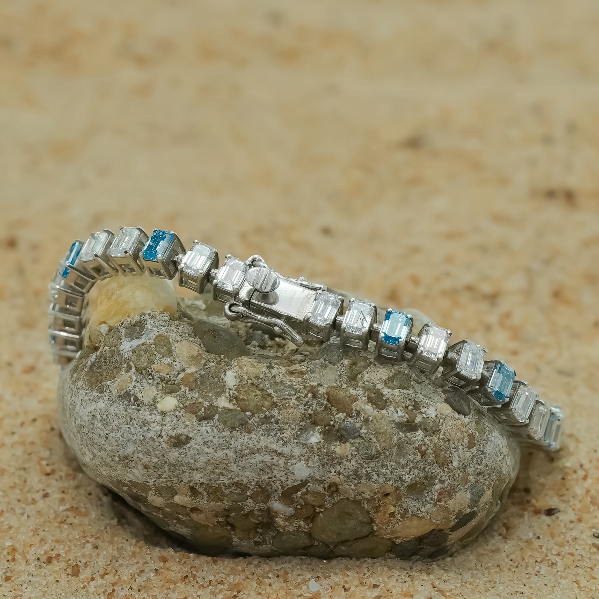 A stunning silver bracelet featuring alternating icy white and ocean-blue gemstones,symbolizing the harmony of nature and luxury.