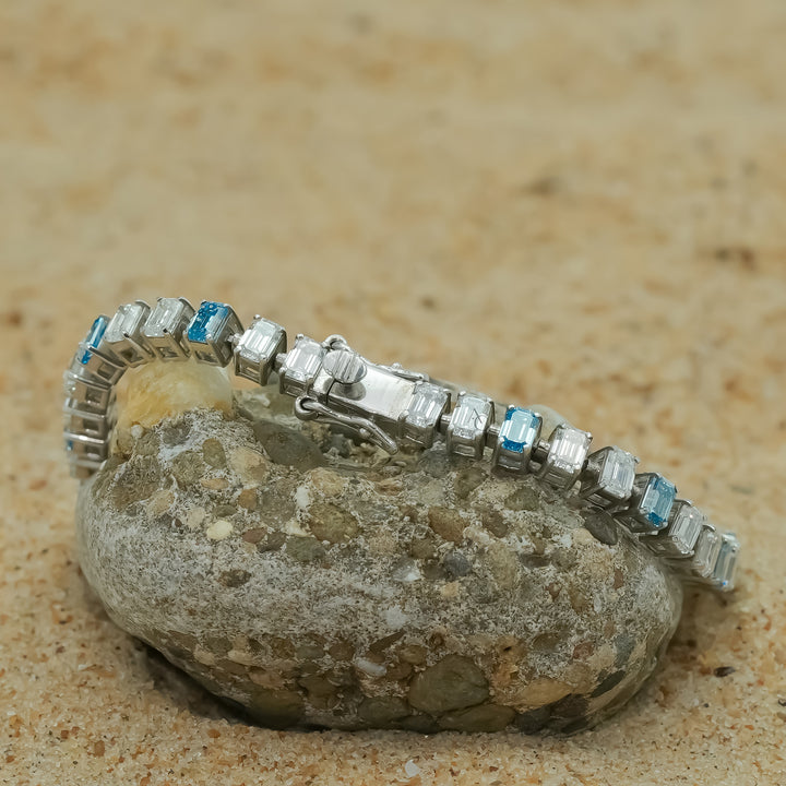A stunning silver bracelet featuring alternating icy white and ocean-blue gemstones,symbolizing the harmony of nature and luxury.