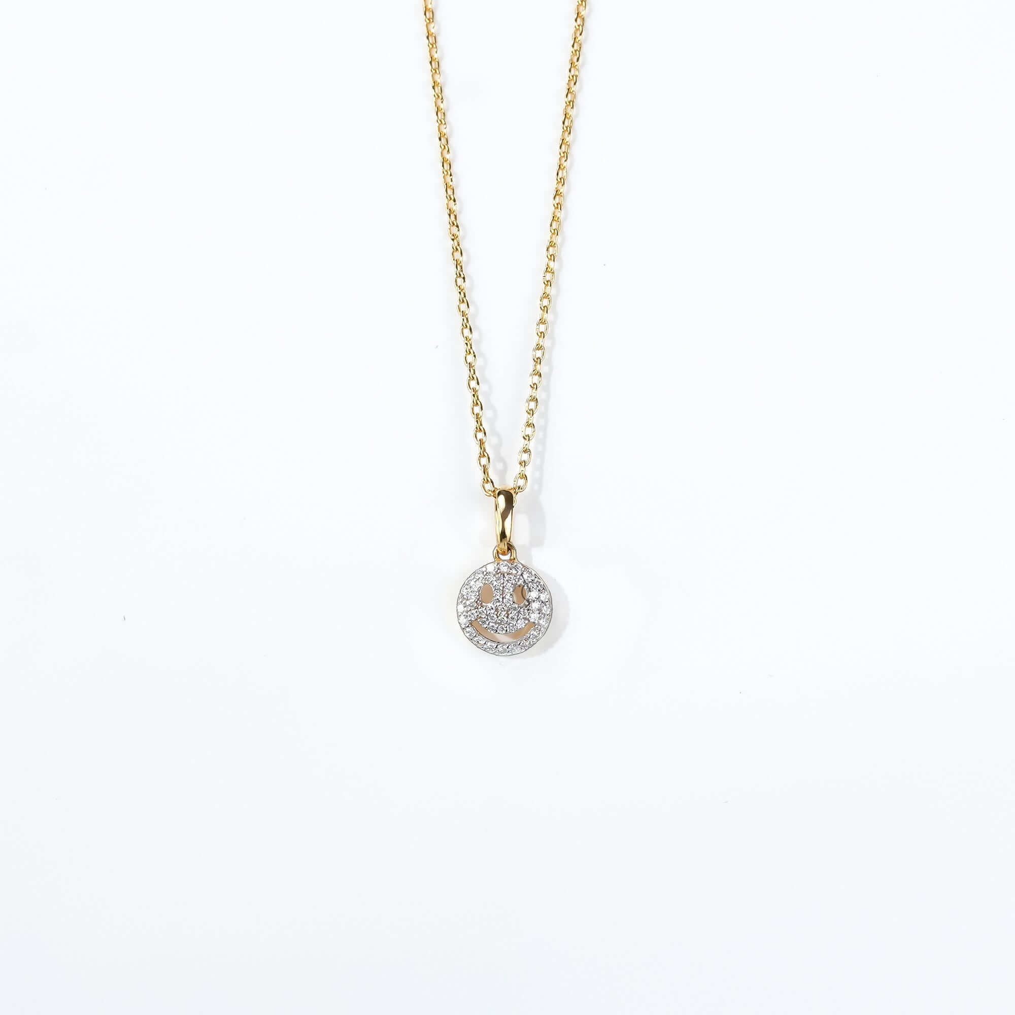 A sparkling smiley pendant on a gold chain, blending joy and elegance a perfect statement of positivity in fine jewelry.
