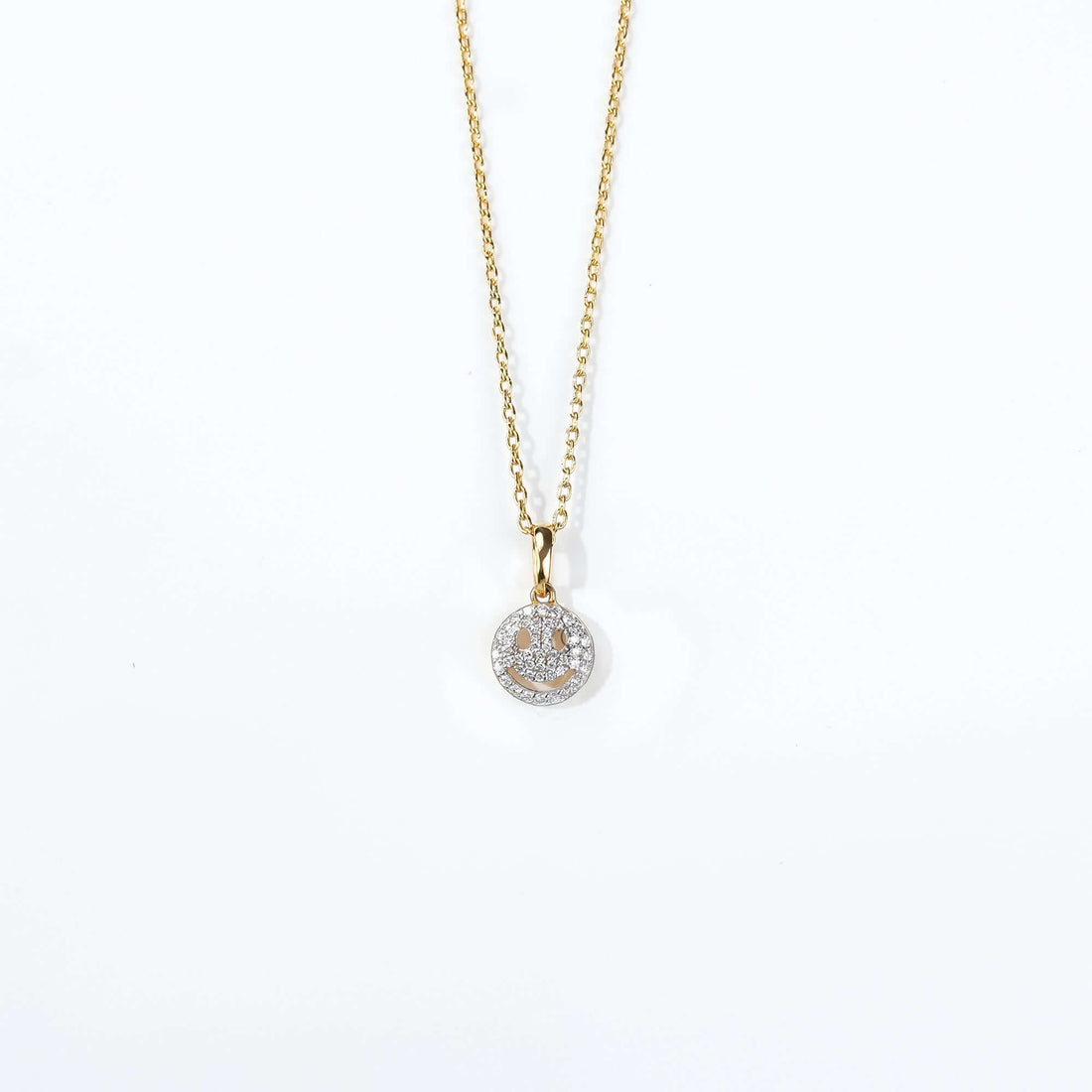 A sparkling smiley pendant on a gold chain, blending joy and elegance a perfect statement of positivity in fine jewelry.