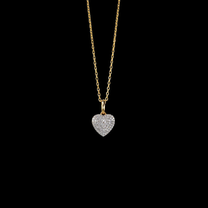 A gold chain necklace with a diamond-studded heart pendant, symbolizing love and timeless elegance.