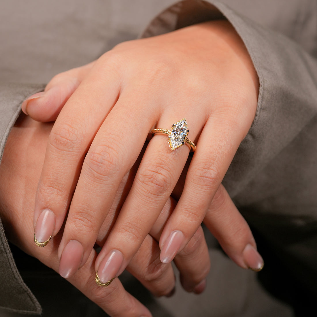 Vintage-inspired marquise-cut diamond ring in polished yellow gold band.