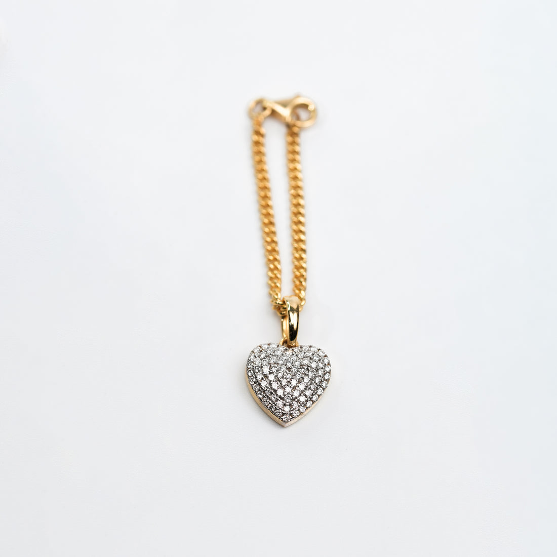 A sophisticated two-tone metal bracelet watch styled with a gold chain and a heart-shaped diamond charm, offering a chic blend of luxury and romance.