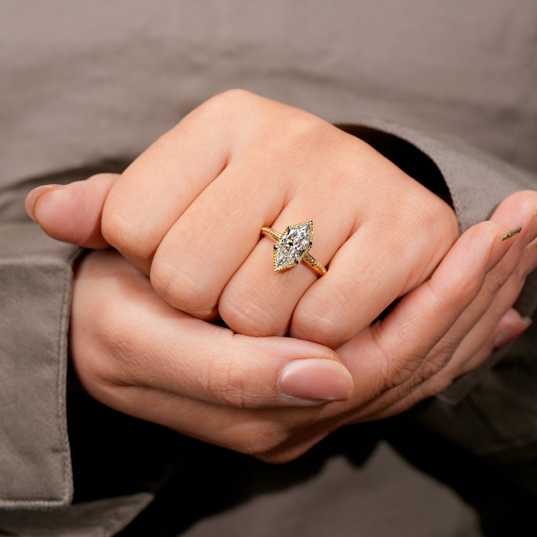 Gold marquise diamond ring with detailed milgrain edges elegant fine jewelry design.