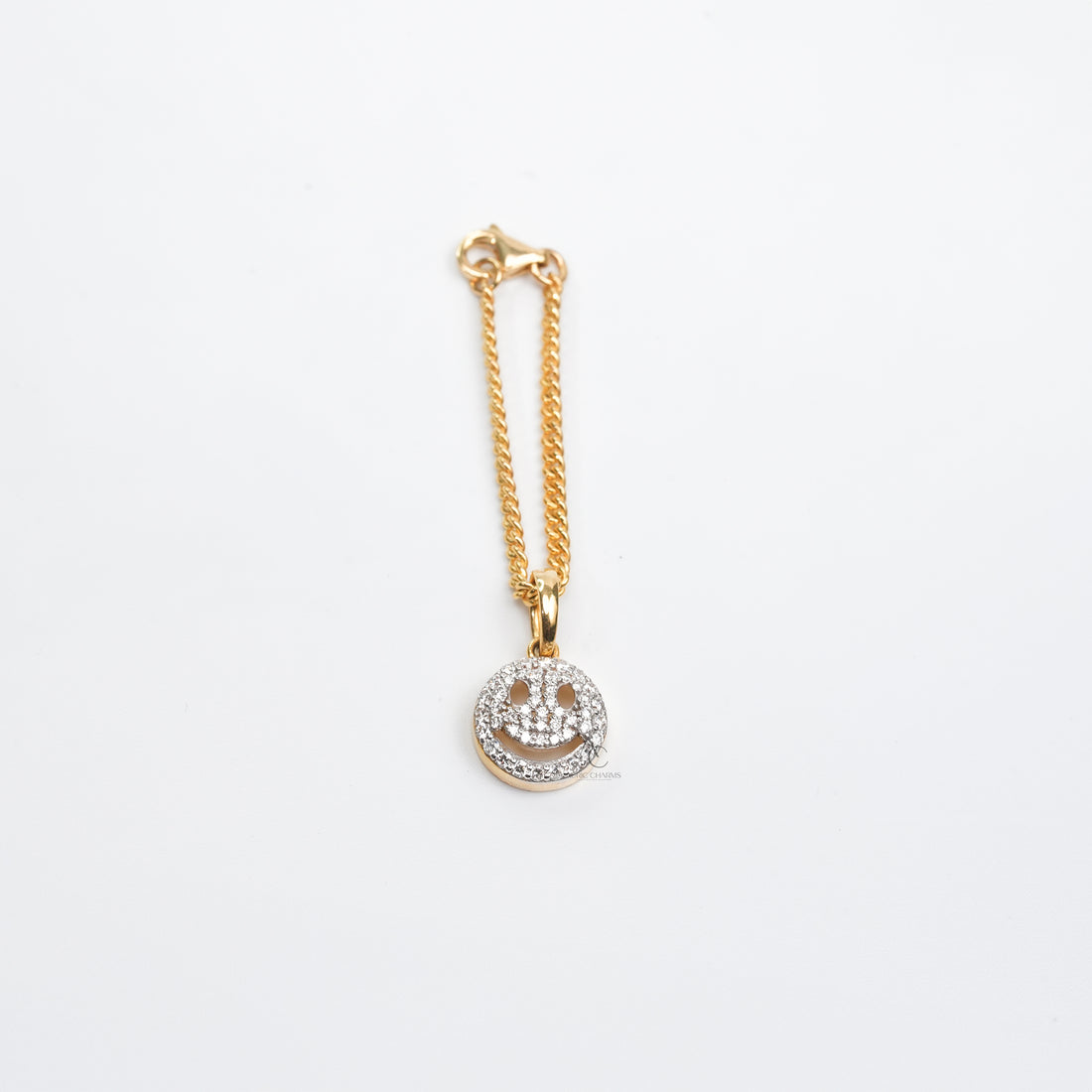 A high-end two-tone bracelet watch enhanced with a delicate gold chain and a diamond-encrusted smiley charm, symbolizing playful elegance and sophistication.
