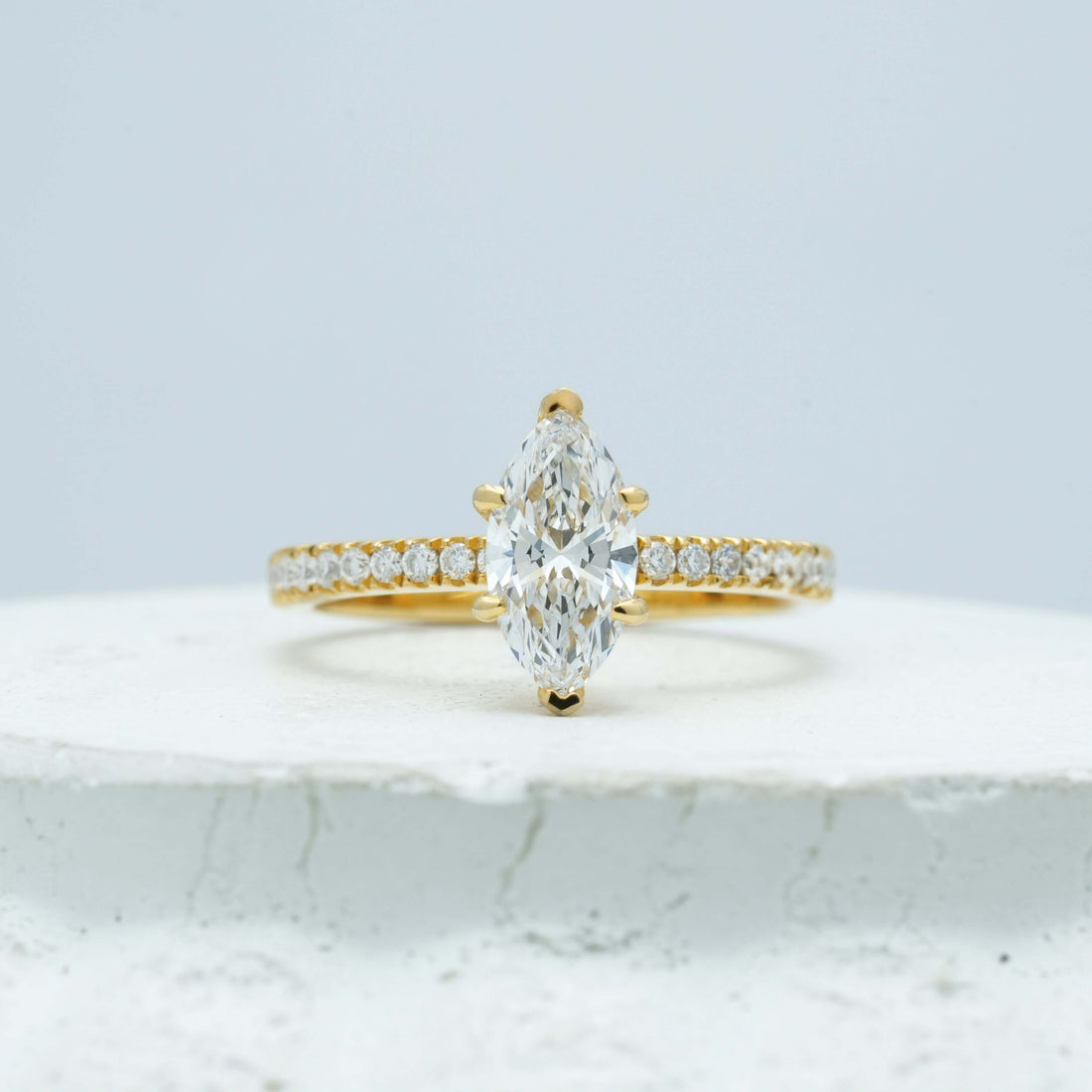 Detailed view of a marquise-cut diamond ring, highlighting the secure mounting and seamless pavé band design