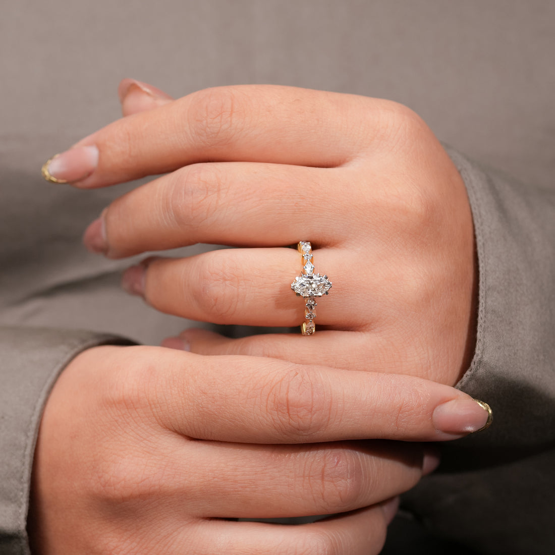 Marquise-cut diamond engagement ring in 14k yellow gold with a detailed band of alternating marquise and round accent diamonds for a radiant, contemporary look.