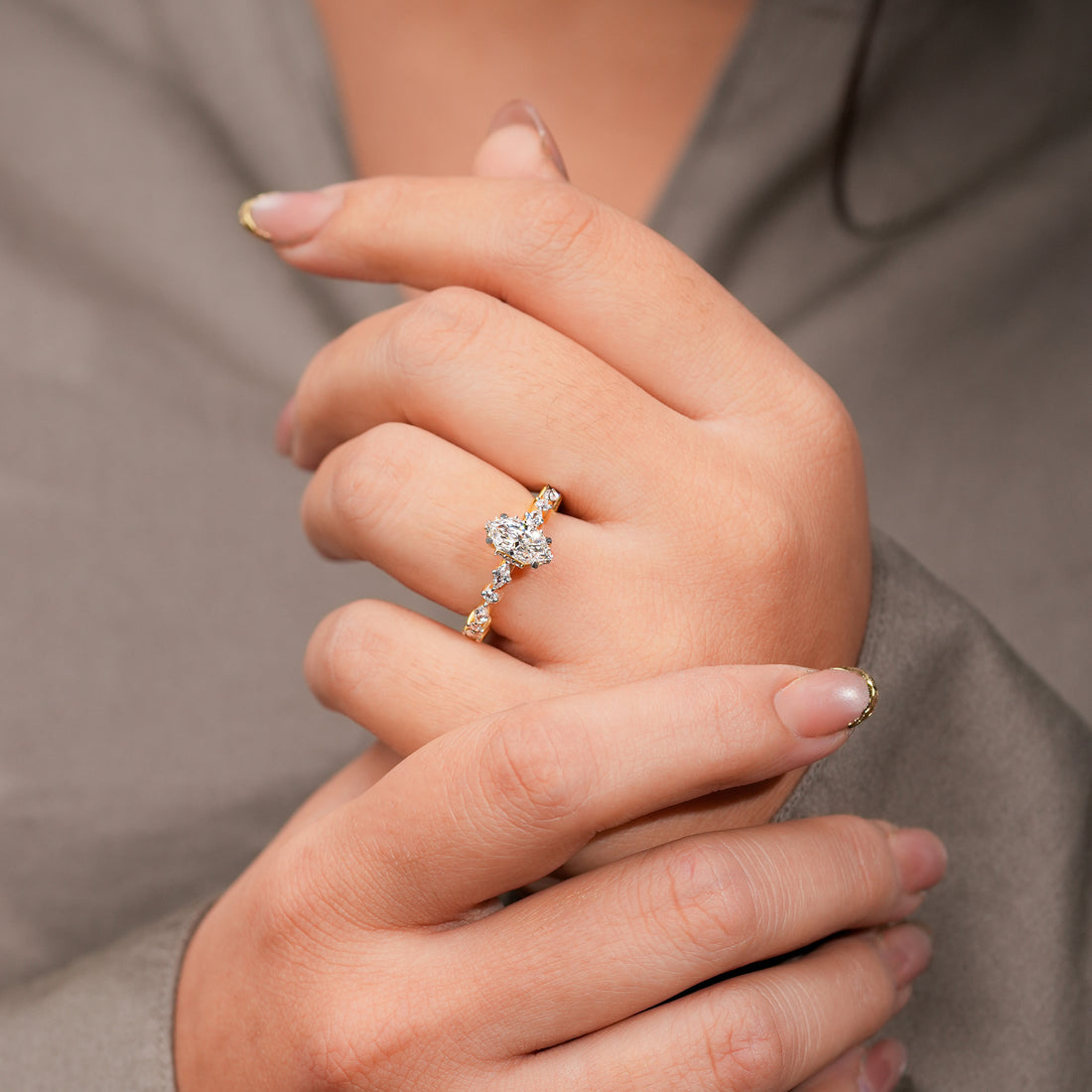 Gold ring with a marquise diamond center and alternating marquise and round accent diamonds along the band.