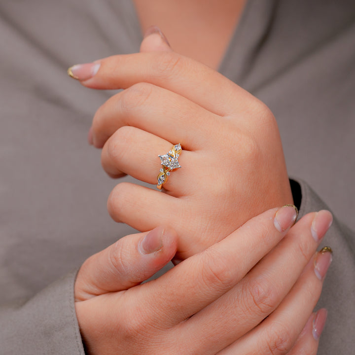 Gold ring with a marquise diamond center and a twisted band of smaller diamonds.