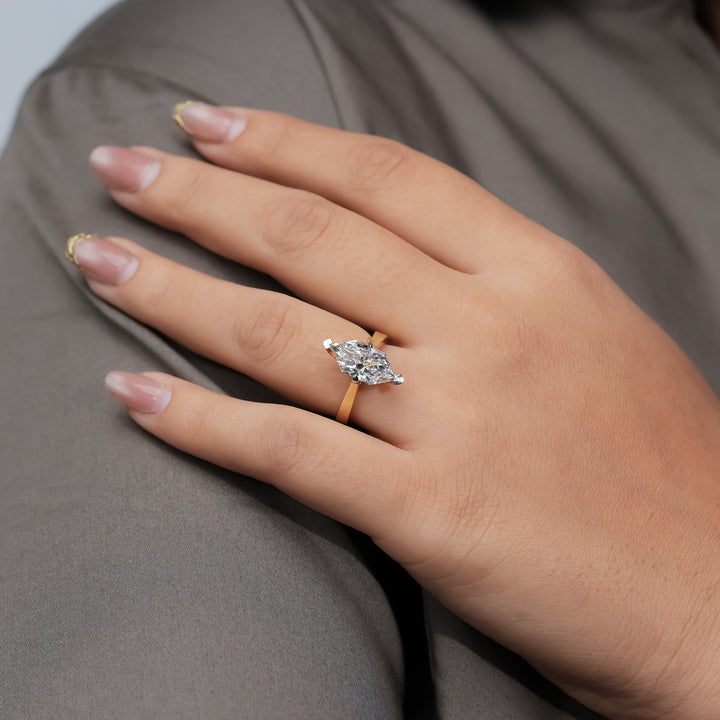 A refined marquise diamond engagement ring crafted in yellow gold, combining sleek simplicity with the brilliance of a precisely cut center stone.