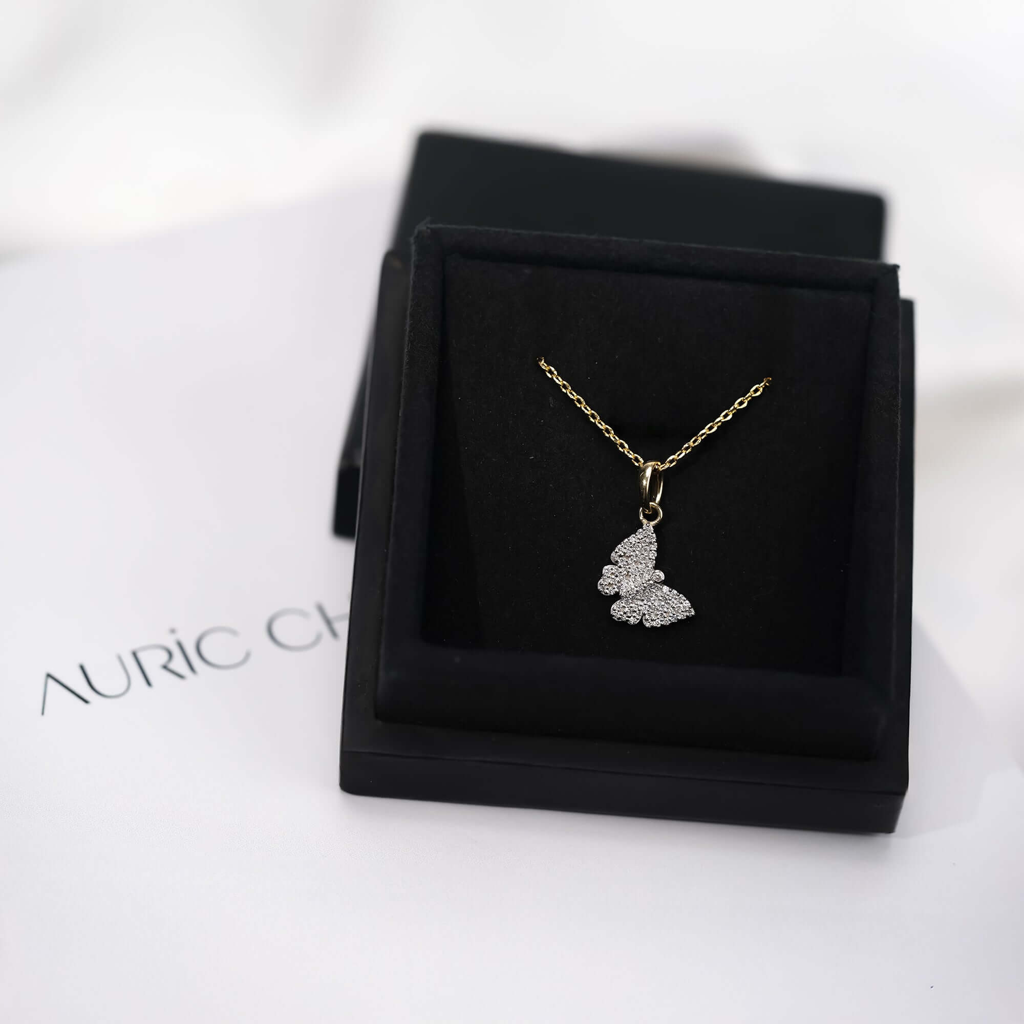 Gold butterfly pendant necklace with diamond pavé, a delicate jewelry piece ideal for gifting or everyday elegance.