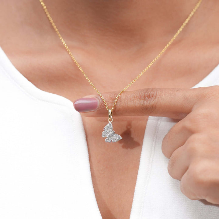 A dainty gold necklace with a butterfly-shaped pendant encrusted with diamonds, symbolizing beauty, transformation, and grace.