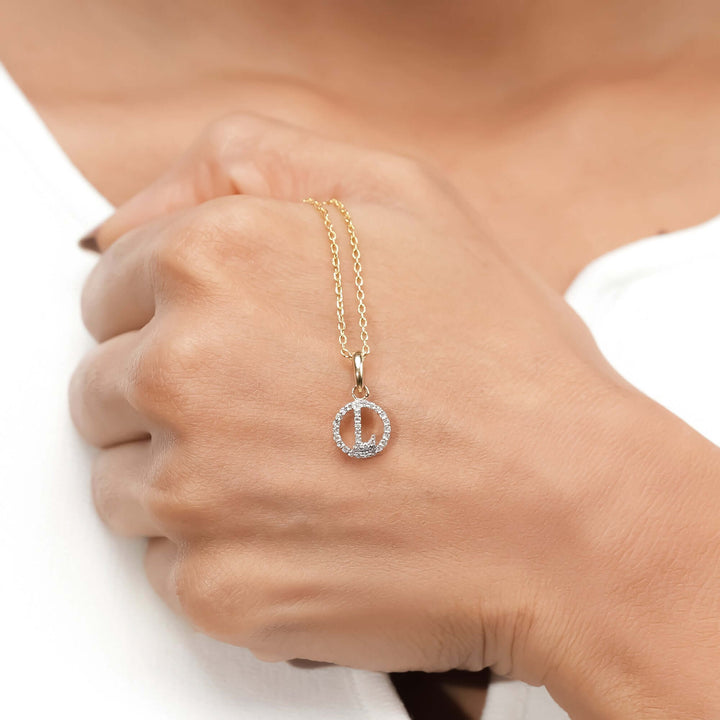 A refined gold necklace with a circular diamond pendant, captured against a white backdrop for a sophisticated, minimalist aesthetic.